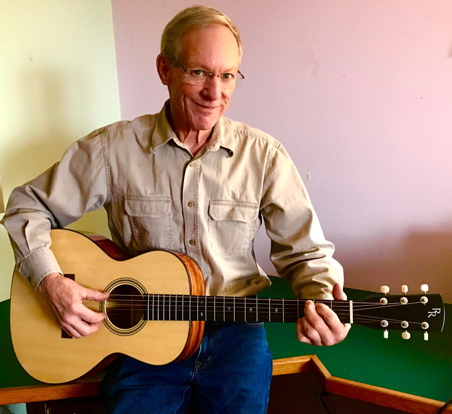    Guitar builder David Riedmiller with one of his instruments, a L-00 style with a German Spruce top and Bees Wing Mahogany body.     
