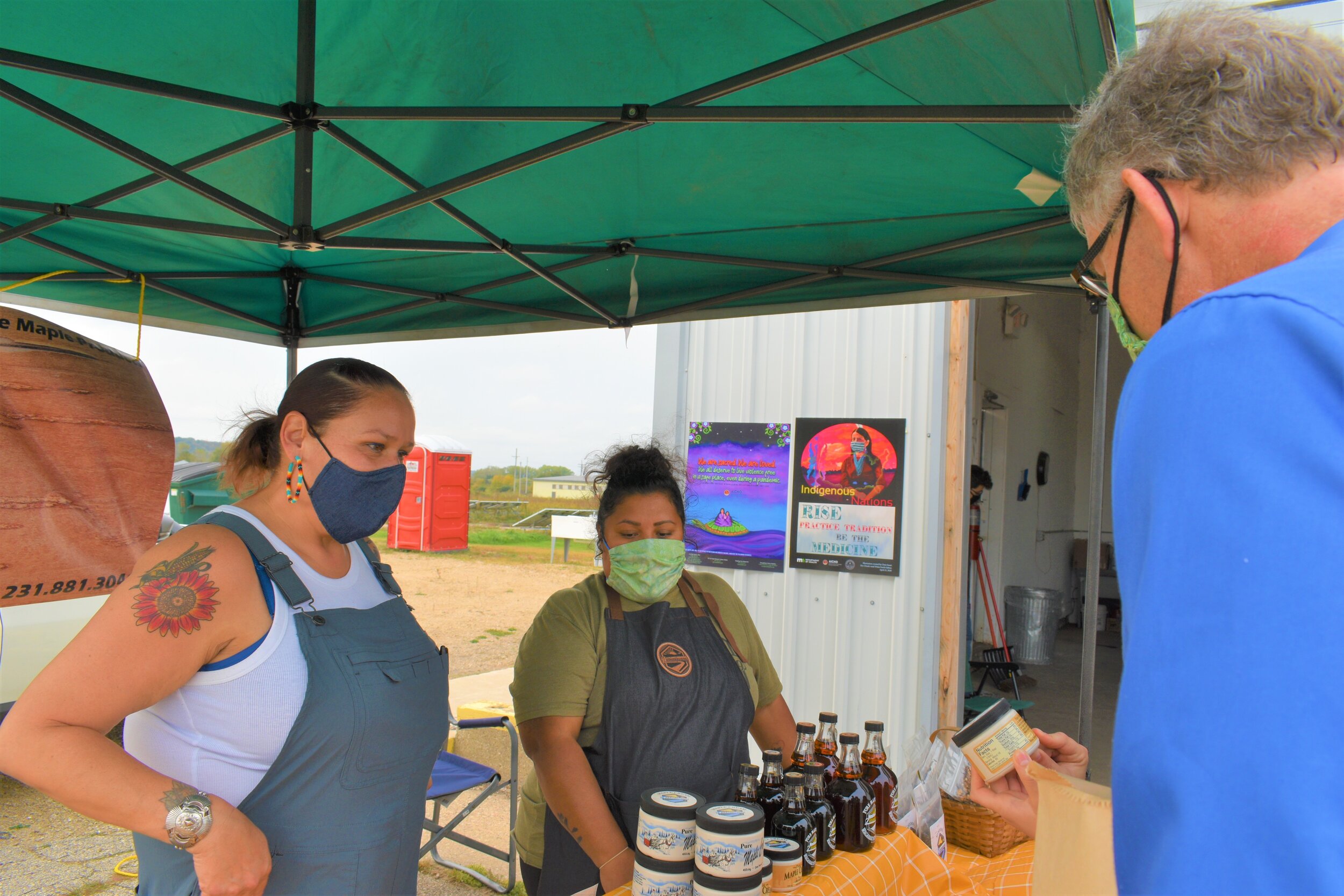  Left, Hoocąk and Executive Chef and Founder of Wild Bearies Elena Terry, with Rosebud Bear Schneider working the Ziibimijwang Farms stand (Ziibimijwang Bay Bands of Odawa Indians Carp Lake, Michigan) as part of the Honoring the Farmers, Foragers, Gr