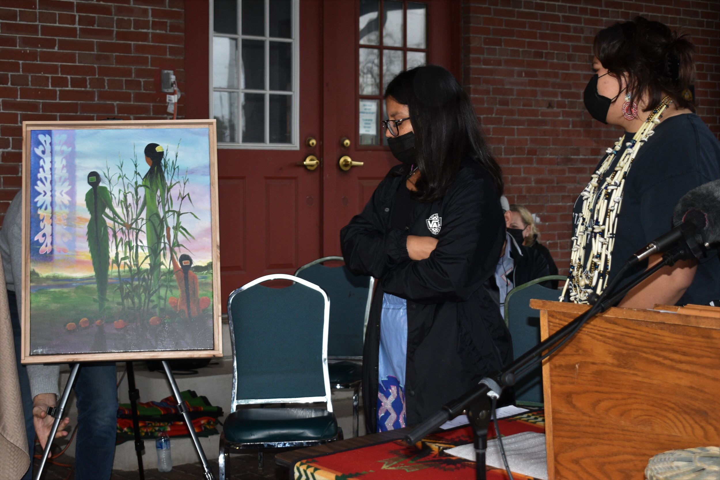 Indigenous Students United of Baraboo High School representatives receive a painting titled ‘The Three Sisters’ painted by Hoocąk/Ojibwe artist Christopher Sweet 