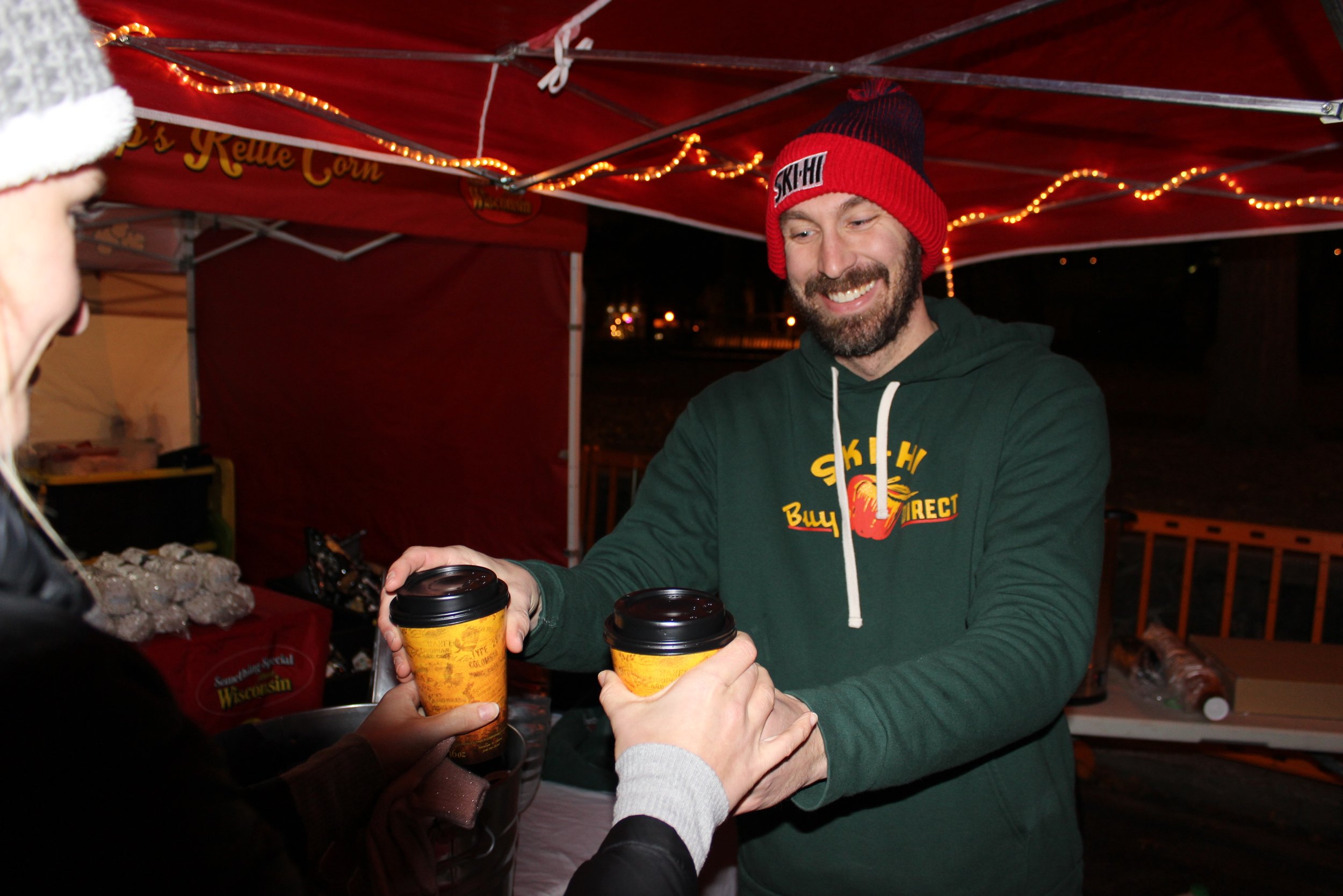  Jake Franzen of Ski Hi Fruit Farm serves cider at a Night Market in December 2019.  Photo by: Ben Bromley 