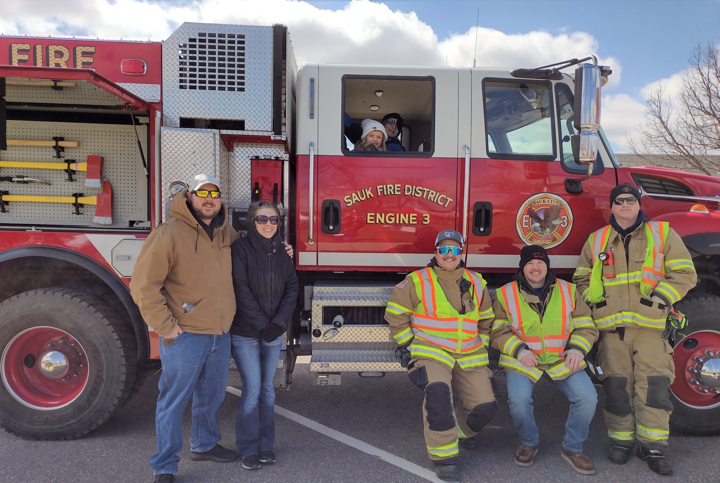  L to R fire fighters Tyler Erickson, Dan Kramer, and Andy Krause with some excited visitors. 