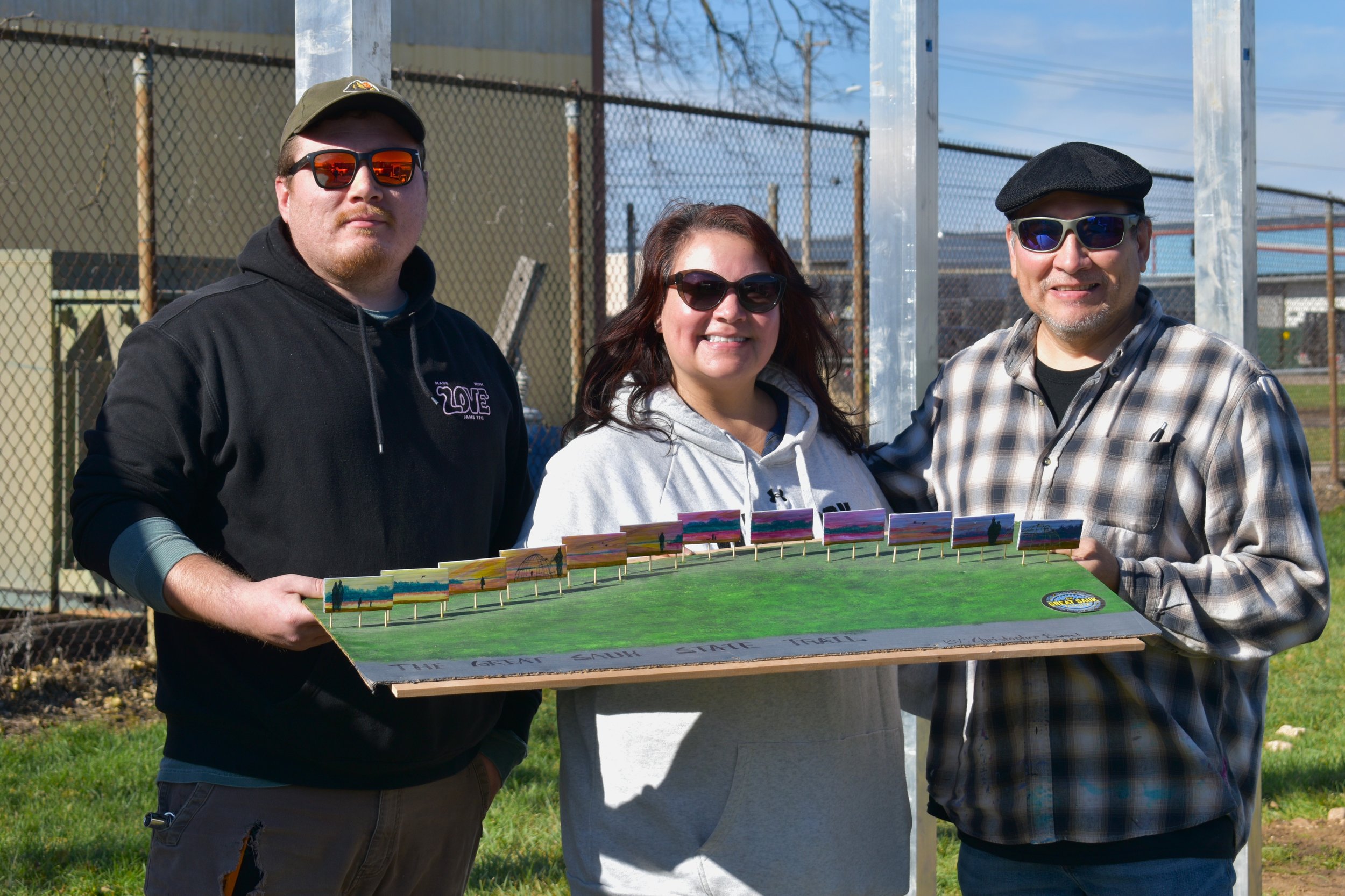  l to r- Austin, Chrissy, and Chris, holding up the scale model of the proposed mural. 
