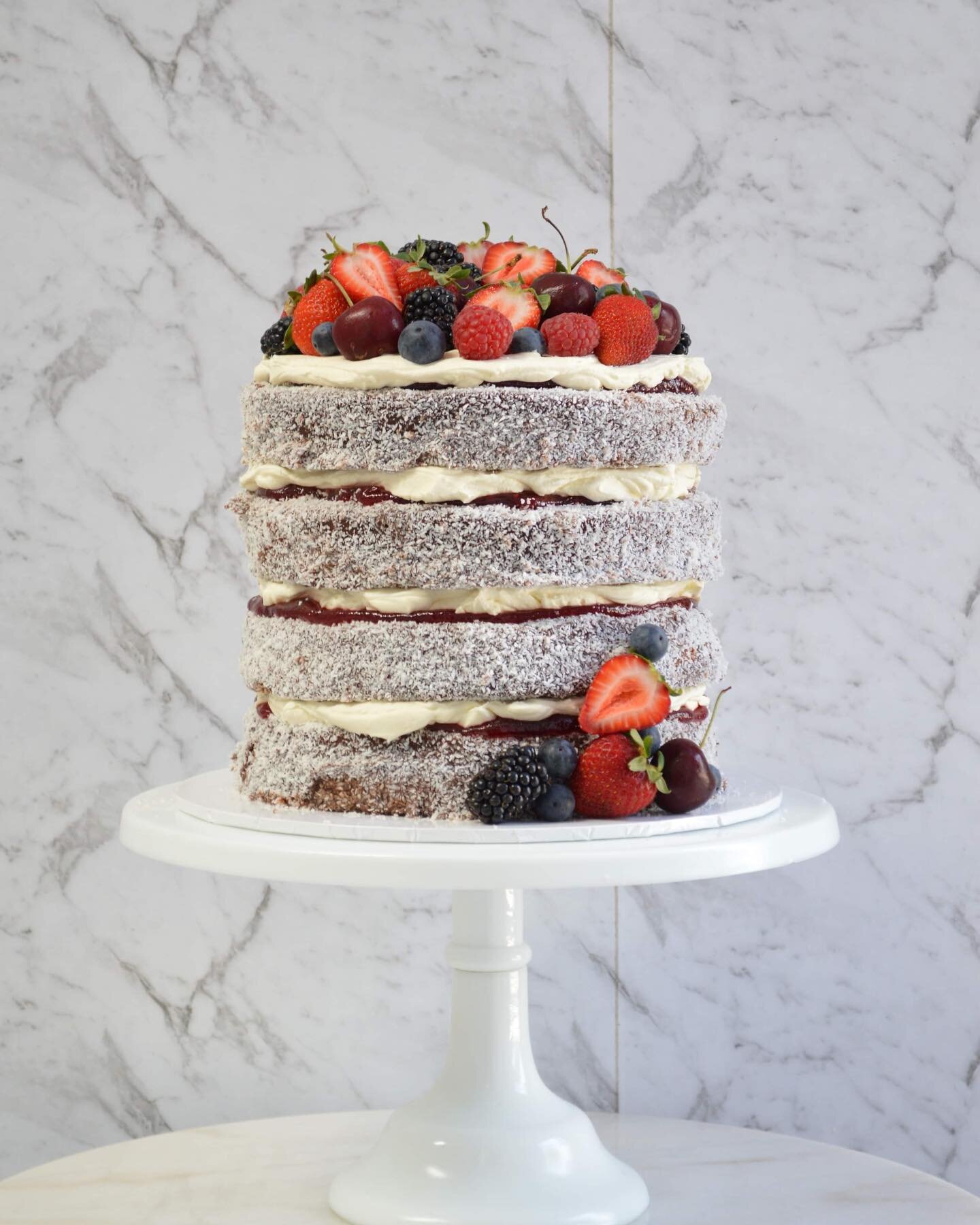 🤤 L A M I N G T O N 🤤
One of our last cakes for 2023 was this delicious lamington cake for a wedding! 
Layers of vanilla cake dipped in a chocolate glaze covered in coconut, layered with raspberry jam and fresh cream 🤤
.
.
.
.
.
#lamington #laming