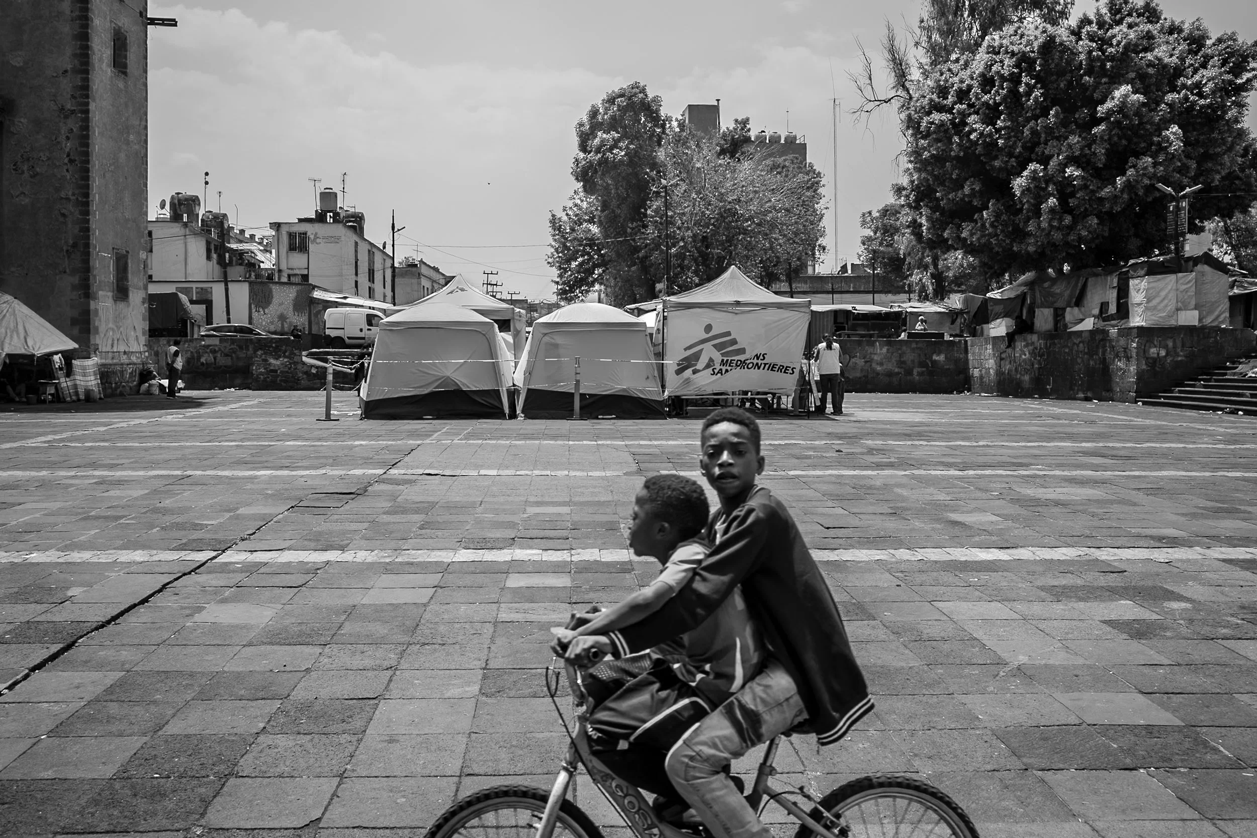 On Sundays, NGO volunteers gather in the square between the church and the field to offer various free medical services.