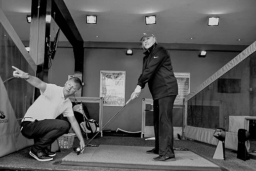 Duncan Woolger teaching a lady to play golf-2.jpg