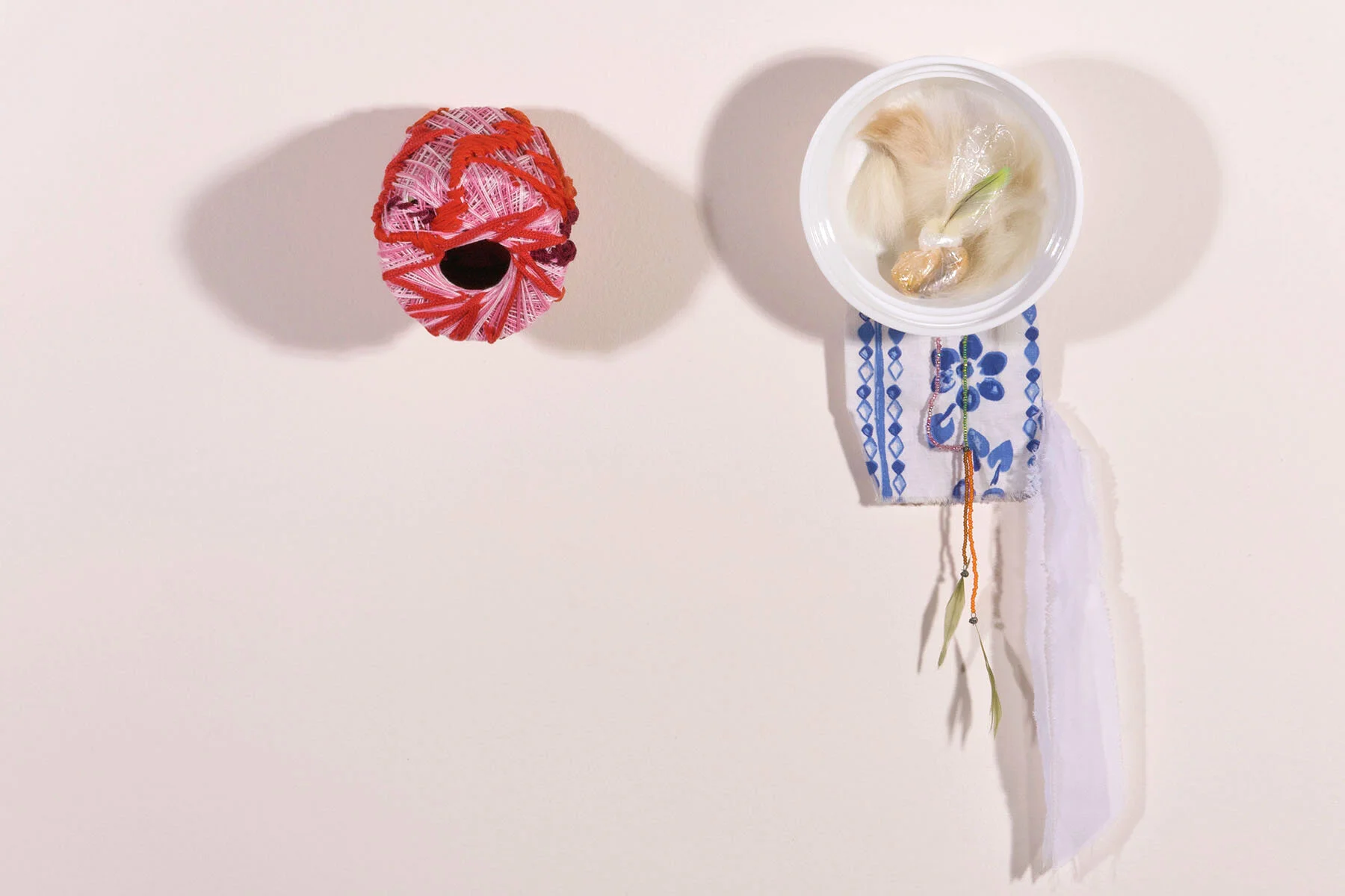 Mimi: (Left) Mending Together-String spool, thread. Bibi: (Right) Reconstruct- Bowl, dog hair, found objects