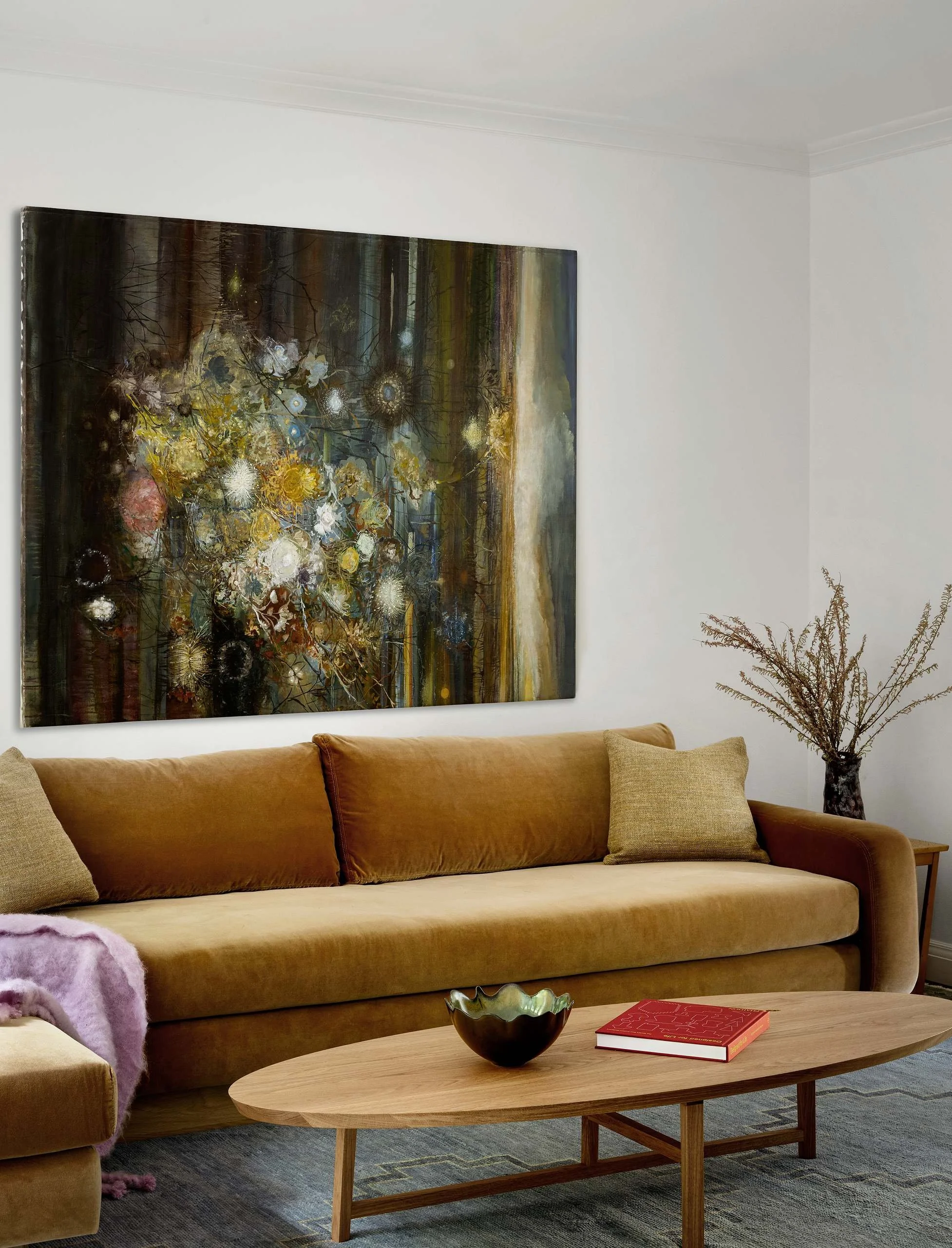 TV room with mustard velvet sofa, oval wood coffee table and a large floral painting, Buena Vista Park, San Francisco