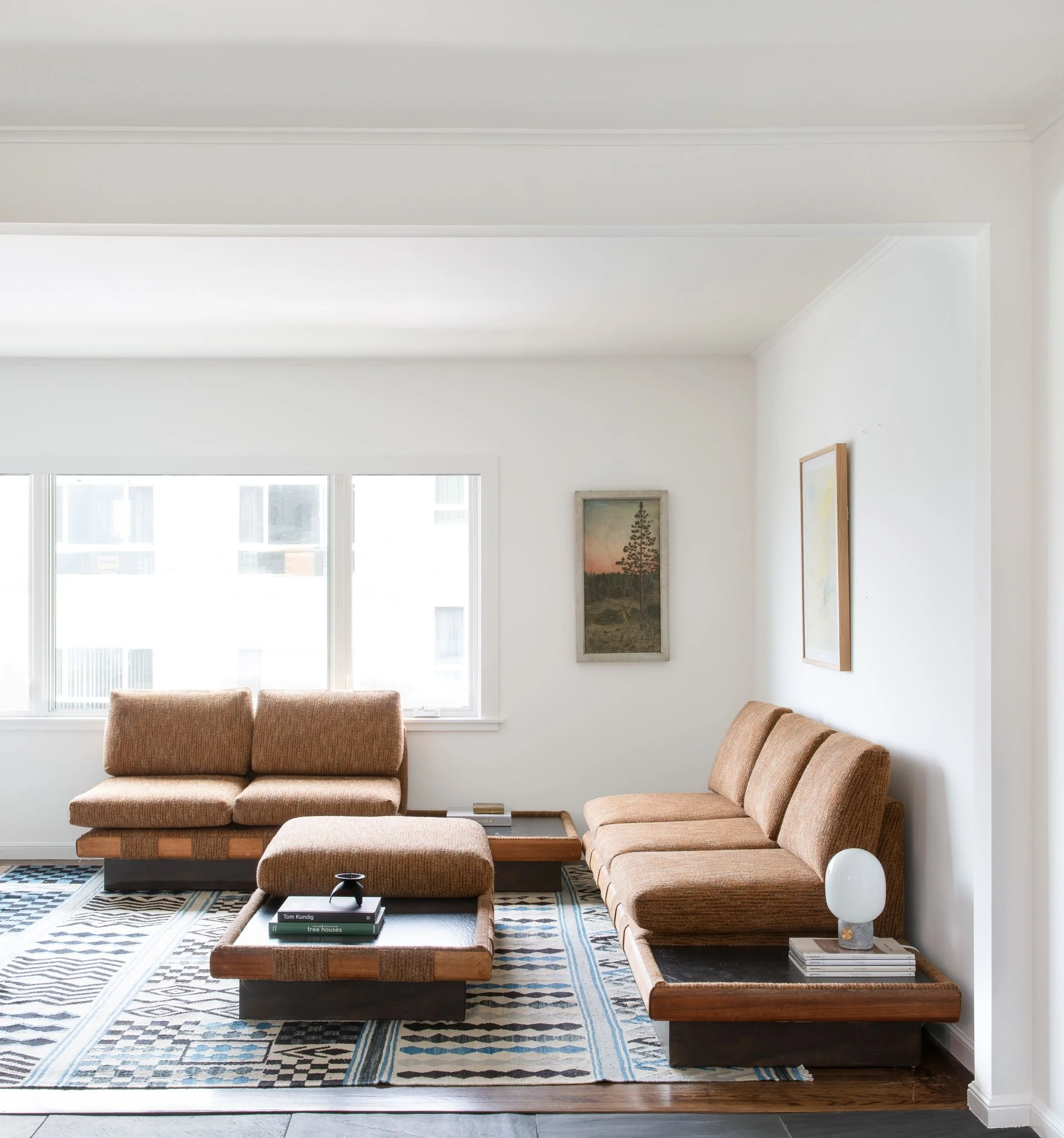 Living room with Adrian Pearsall tan modular sofa on wood plinths and landscape paintings, Golden Gate Heights, San Francisco