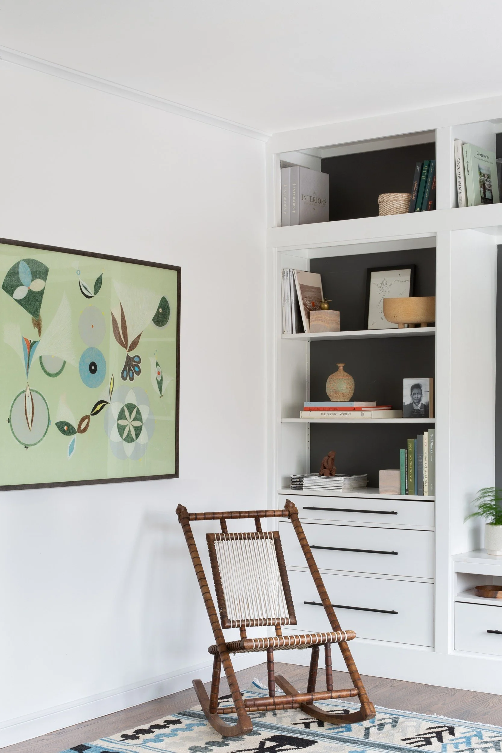 Built-in shelves with a vintage wood rocking chair and green botanical print, Golden Gate Heights, San Francisco