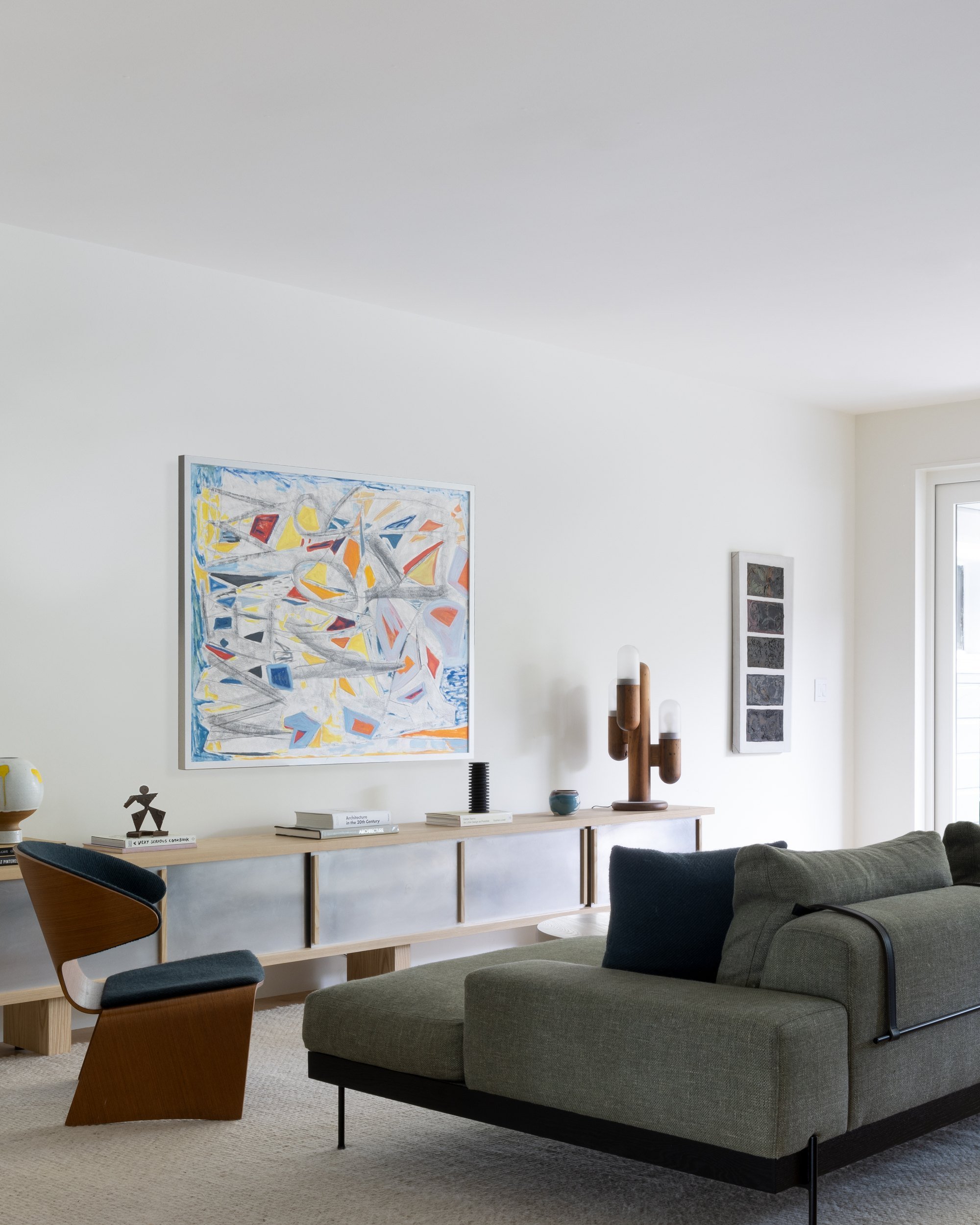 Family room with aluminum and ash console, cactus lamp, green sofa and colorful abstract painting, Cole Valley Edwardian