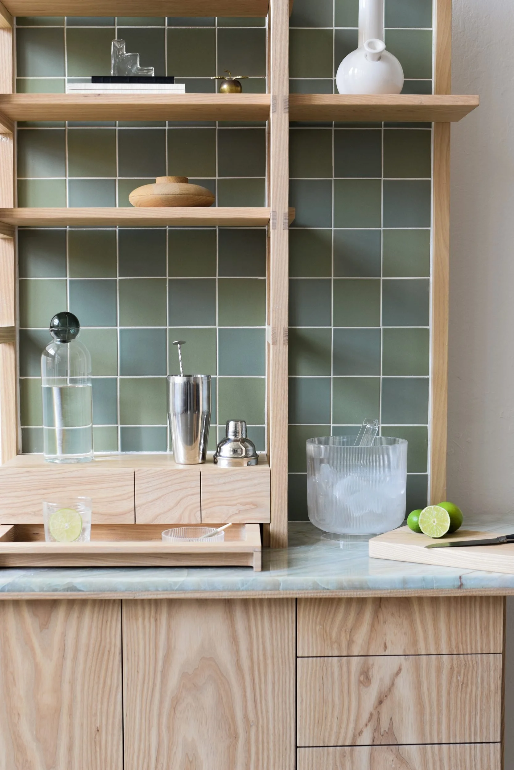 Detail of the High Bar cabinet: green tile, wood shelves, stone counter and bar tools, handbuilt in California