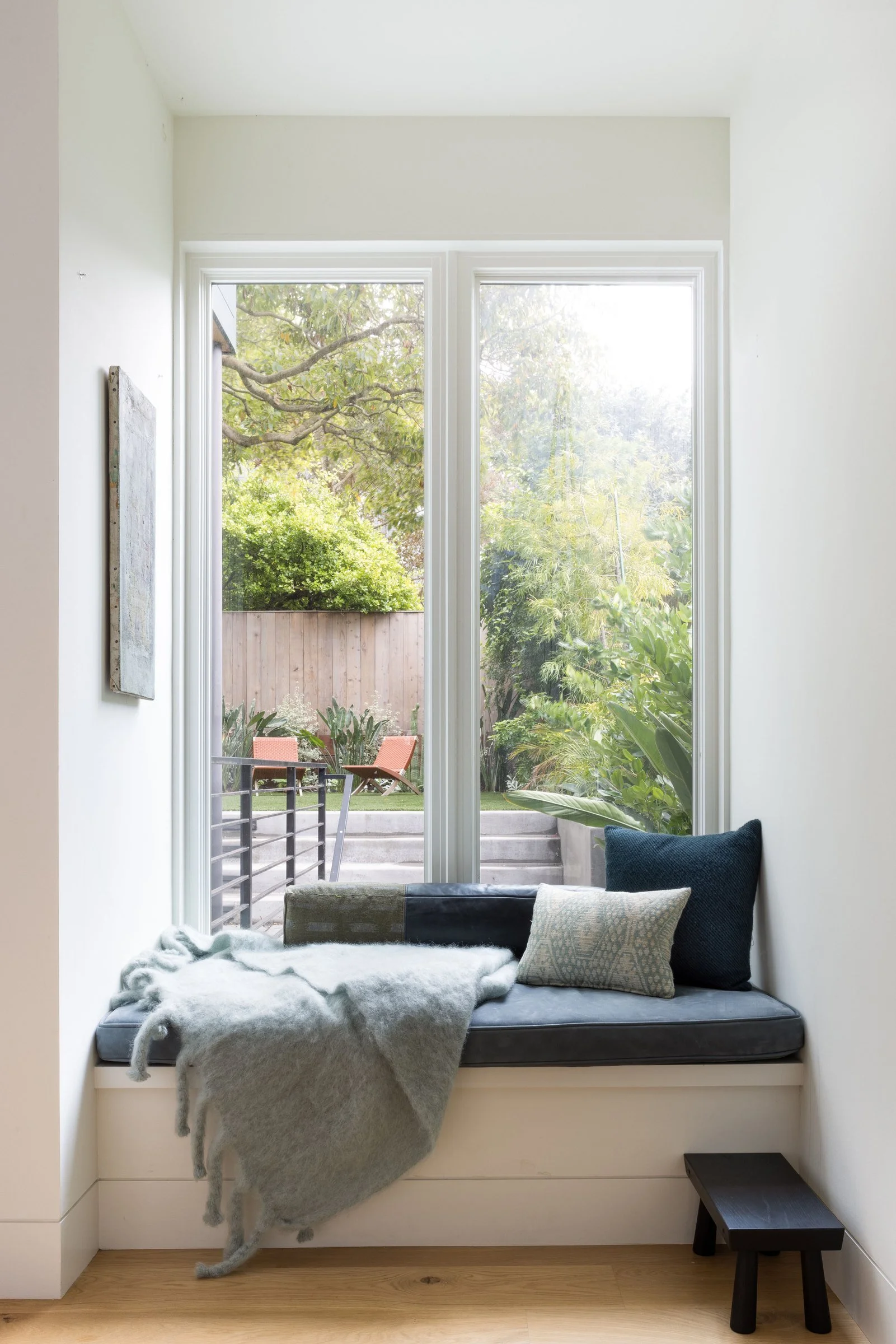 Kitchen and family room window seat with a wool throw, looking out to the garden, in a Cole Valley Edwardian, San Francisco