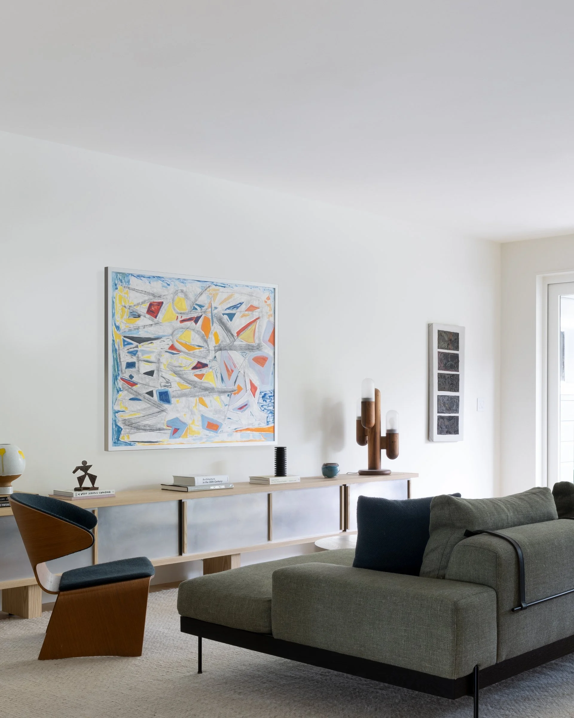 Family room with a 12-foot aluminum and ash console by Brandt Hewitt of Medium Small, a vintage Modeline cactus lamp, and a Croft House sofa, San Francisco