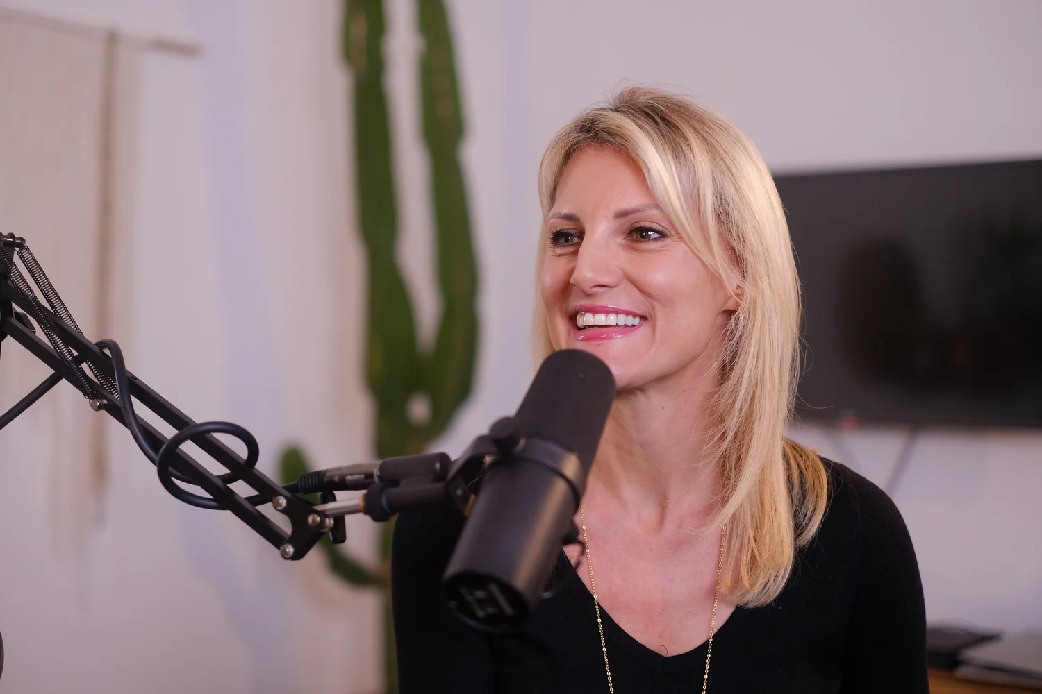 Valerie Morehouse, celebrity vocal coach, smiling at a studio microphone in Los Angeles