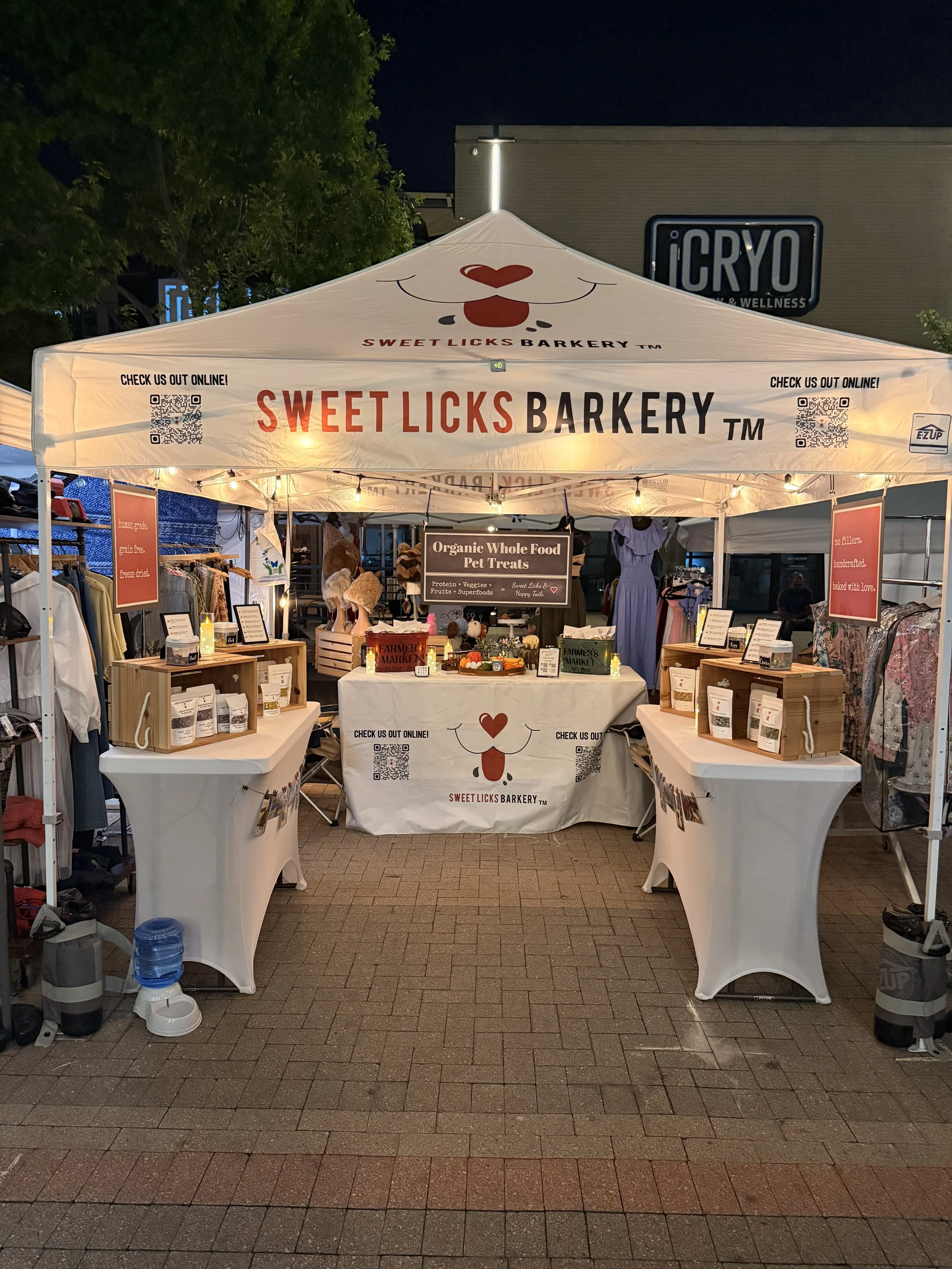 Sweet Licks Barkery booth selling organic dog treats at a local DFW farmers market.