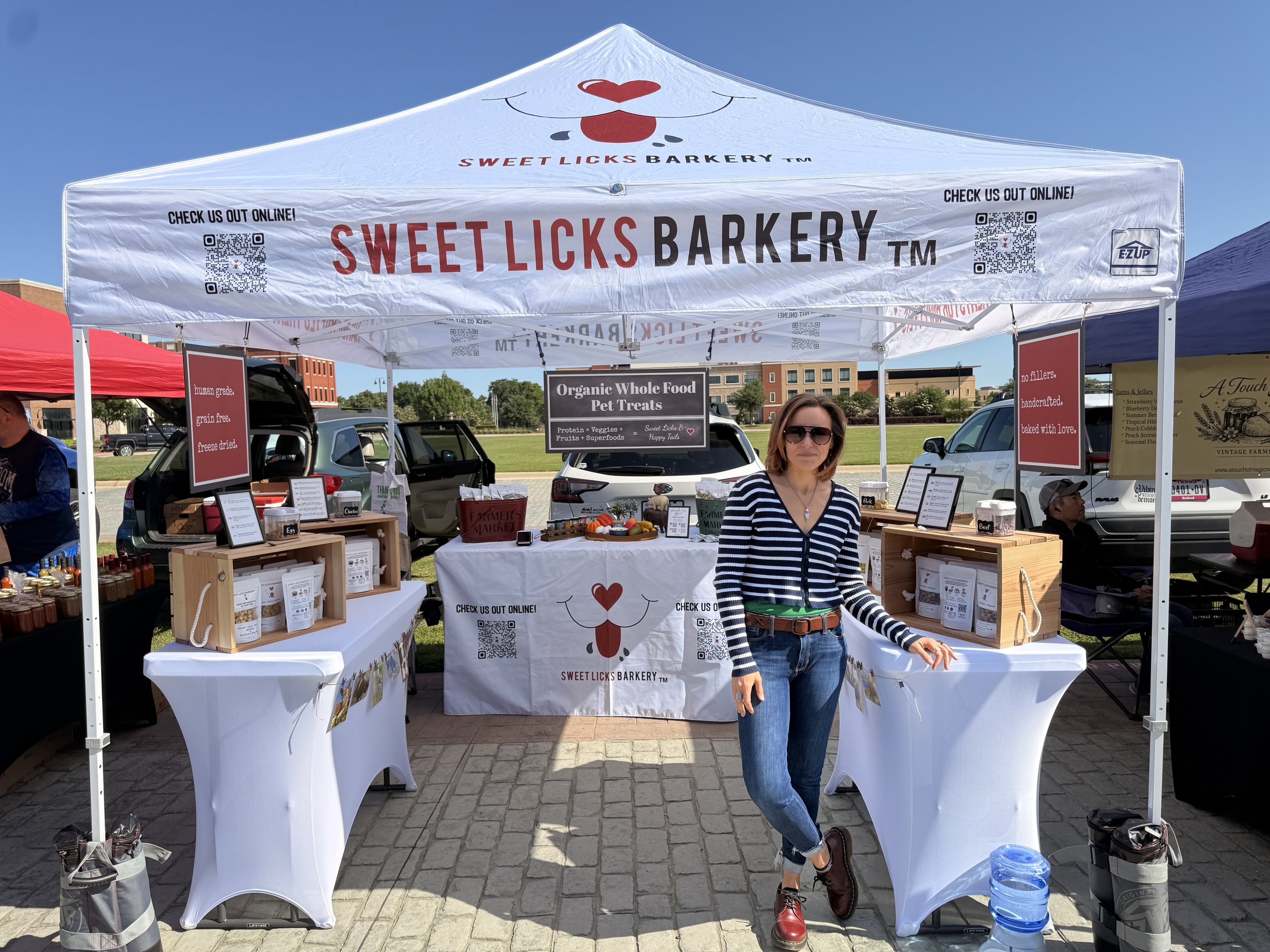 Sweet Licks Barkery booth selling organic dog treats at a local DFW farmers market.