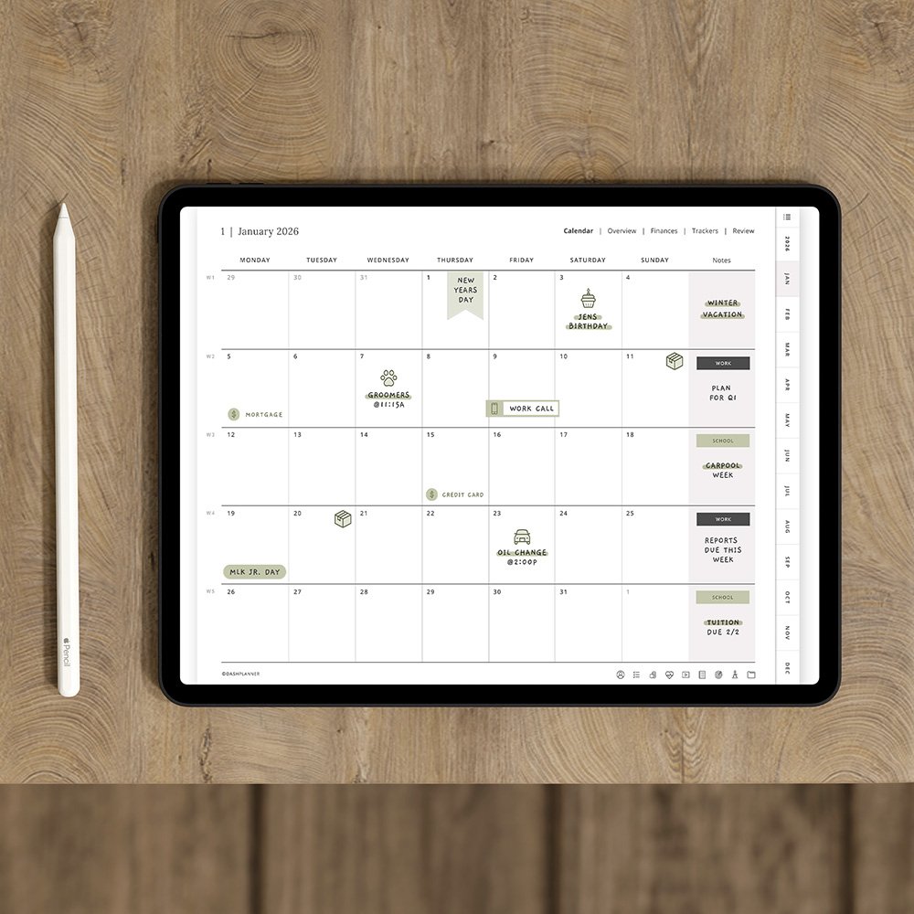 Digital monthly planner on an iPad showing a calendar with functional stickers and month tabs, beside an Apple Pencil
