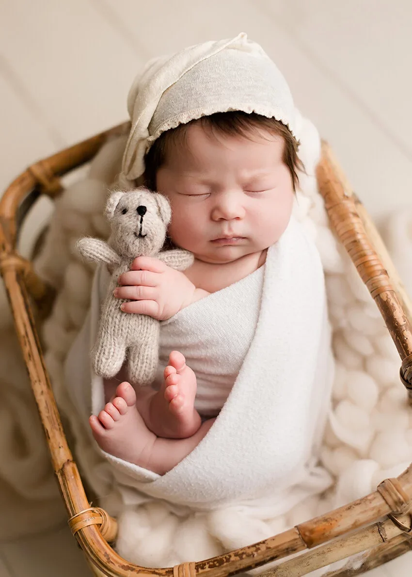 newborn sleeping with teddy bear at a photo studio to show top bay area doulas