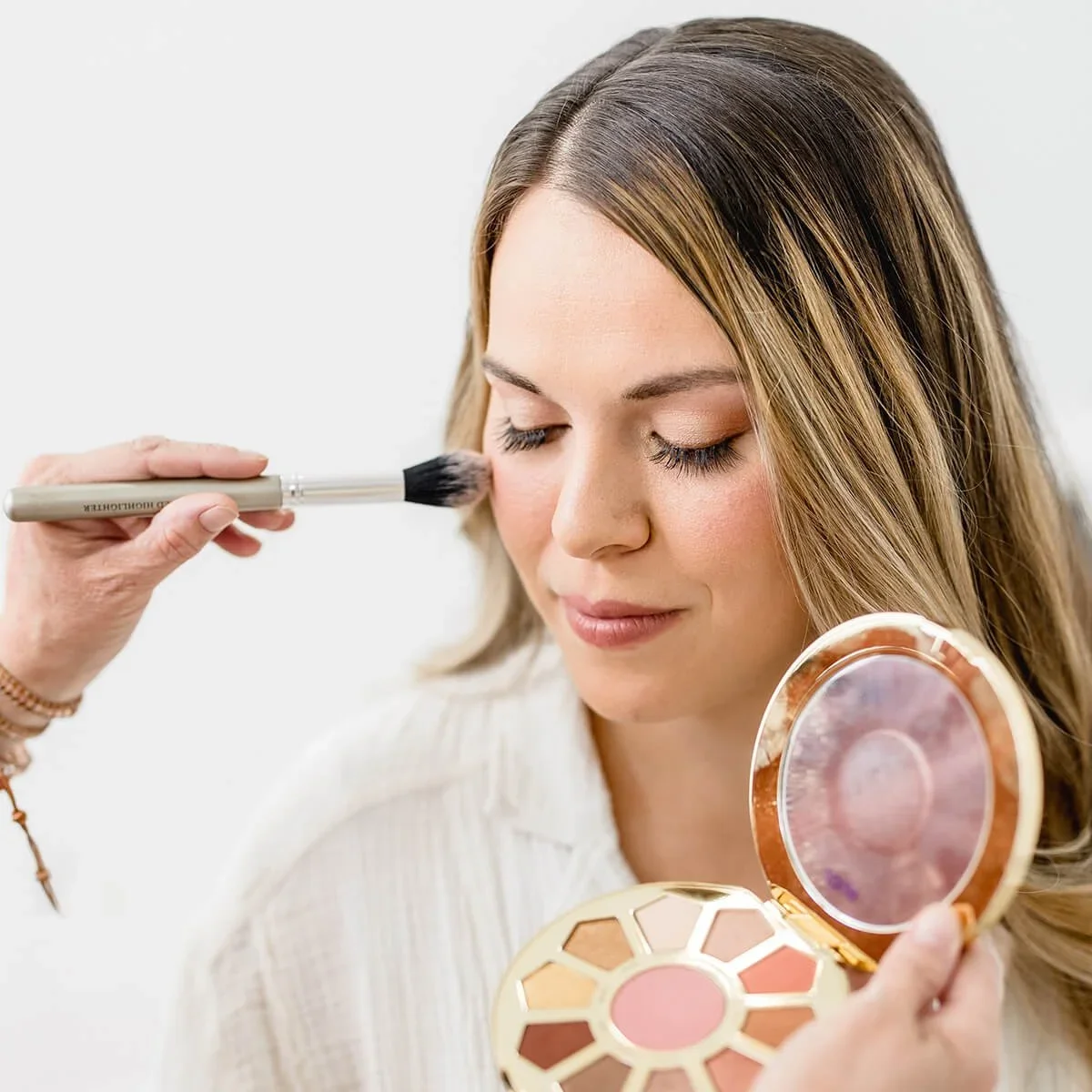 makeup being done before bay area maternity photo session