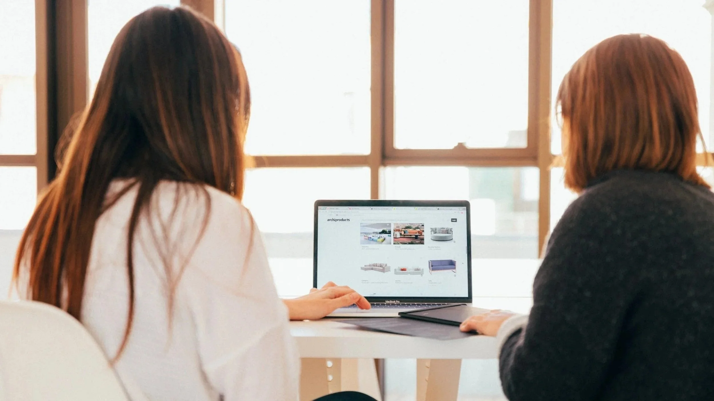 Two women looking at a laptop screen