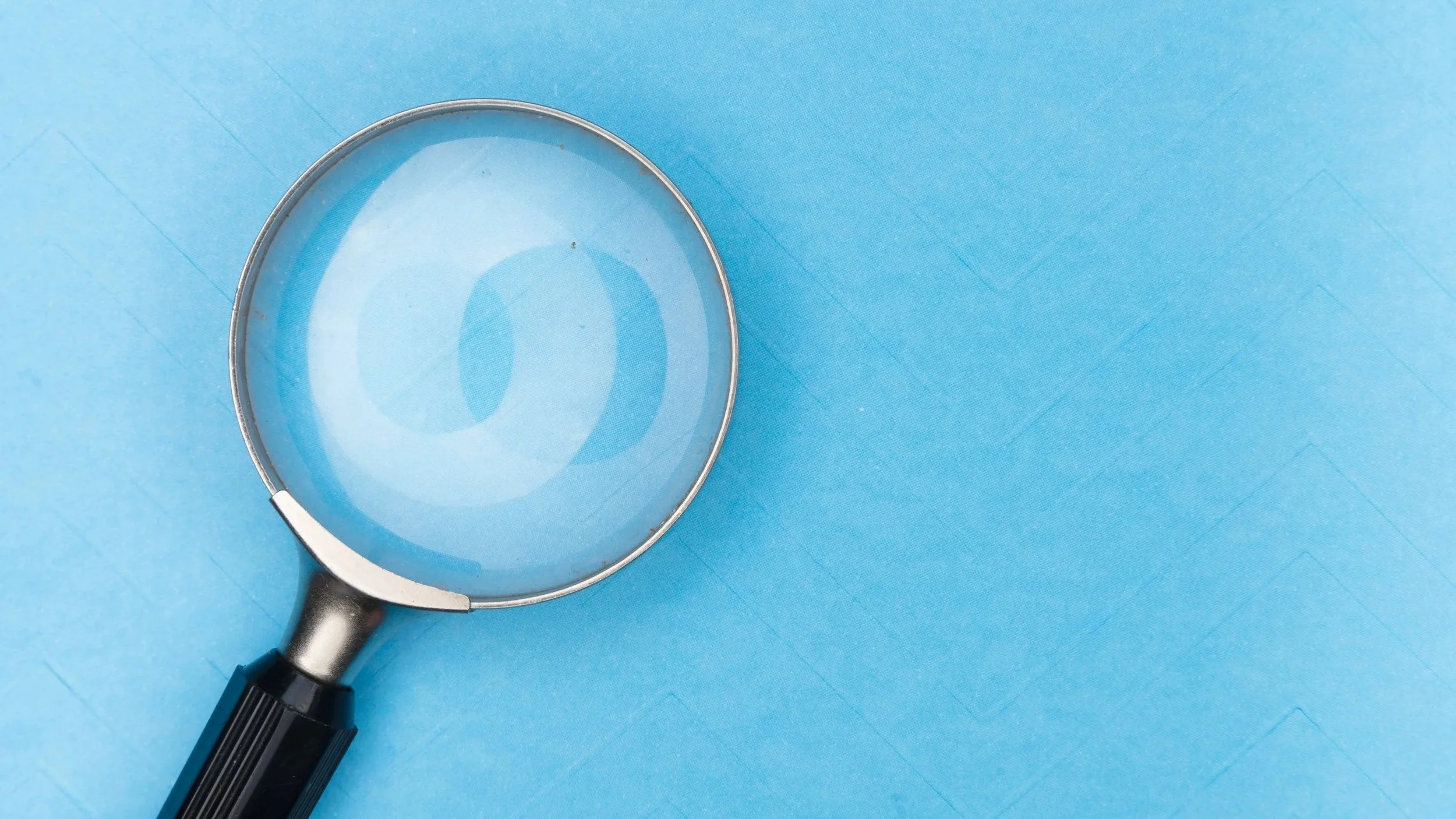 Magnifying glass on blue background