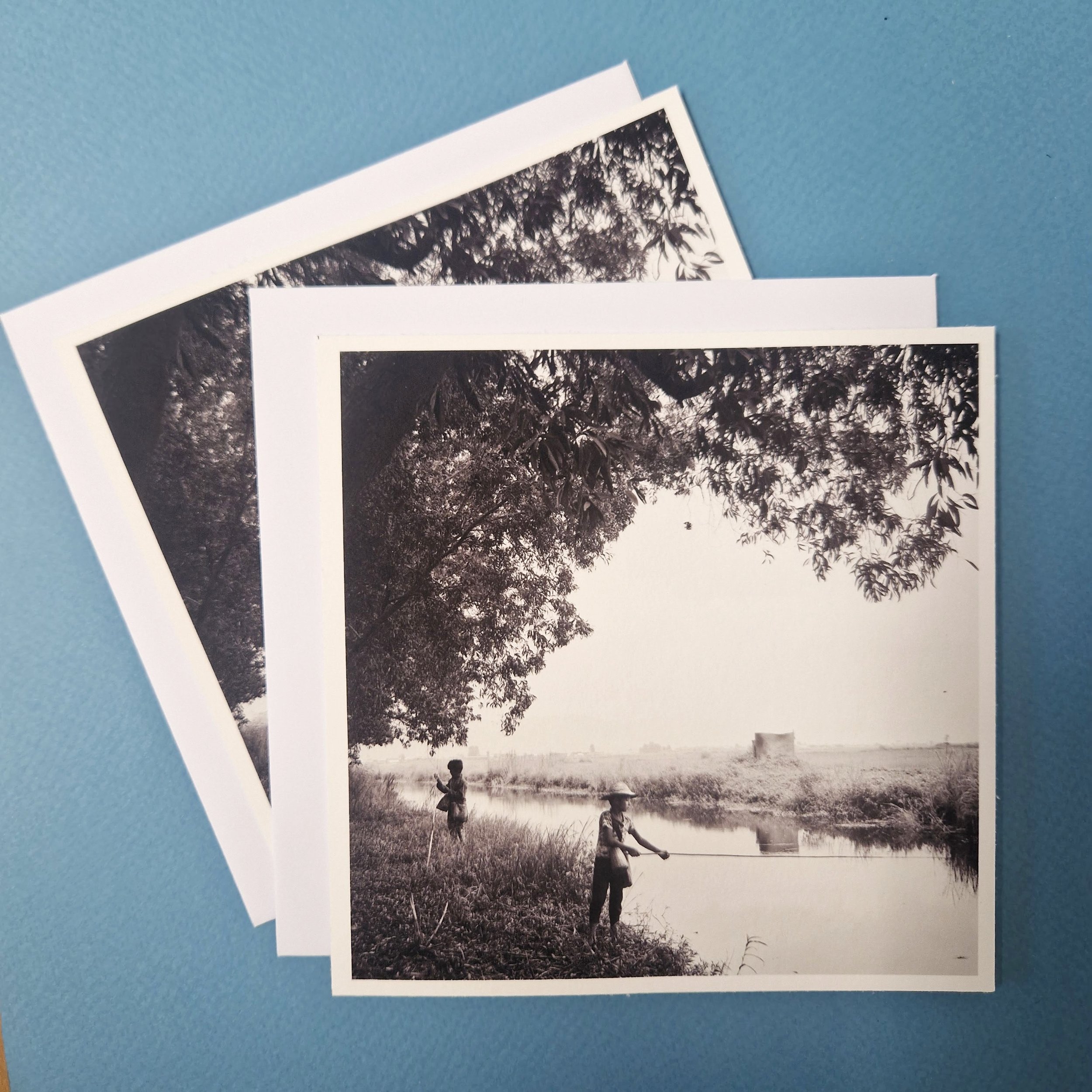 Black and white postcard of two boys fishing by a brook at Nyaungshwe, Burma 2012.