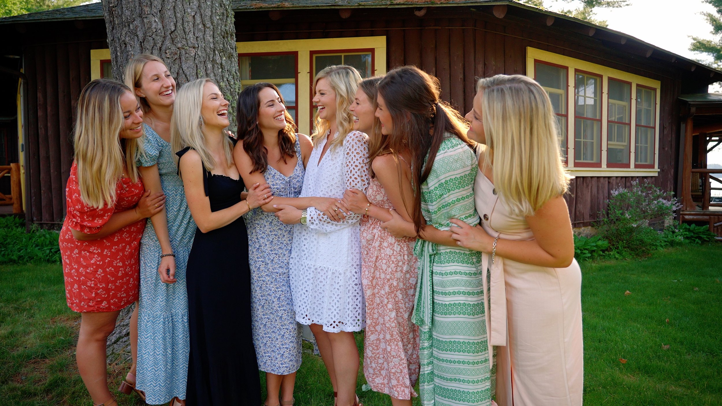 Bride with her bridesmaids taking photos at a rehearsal dinner