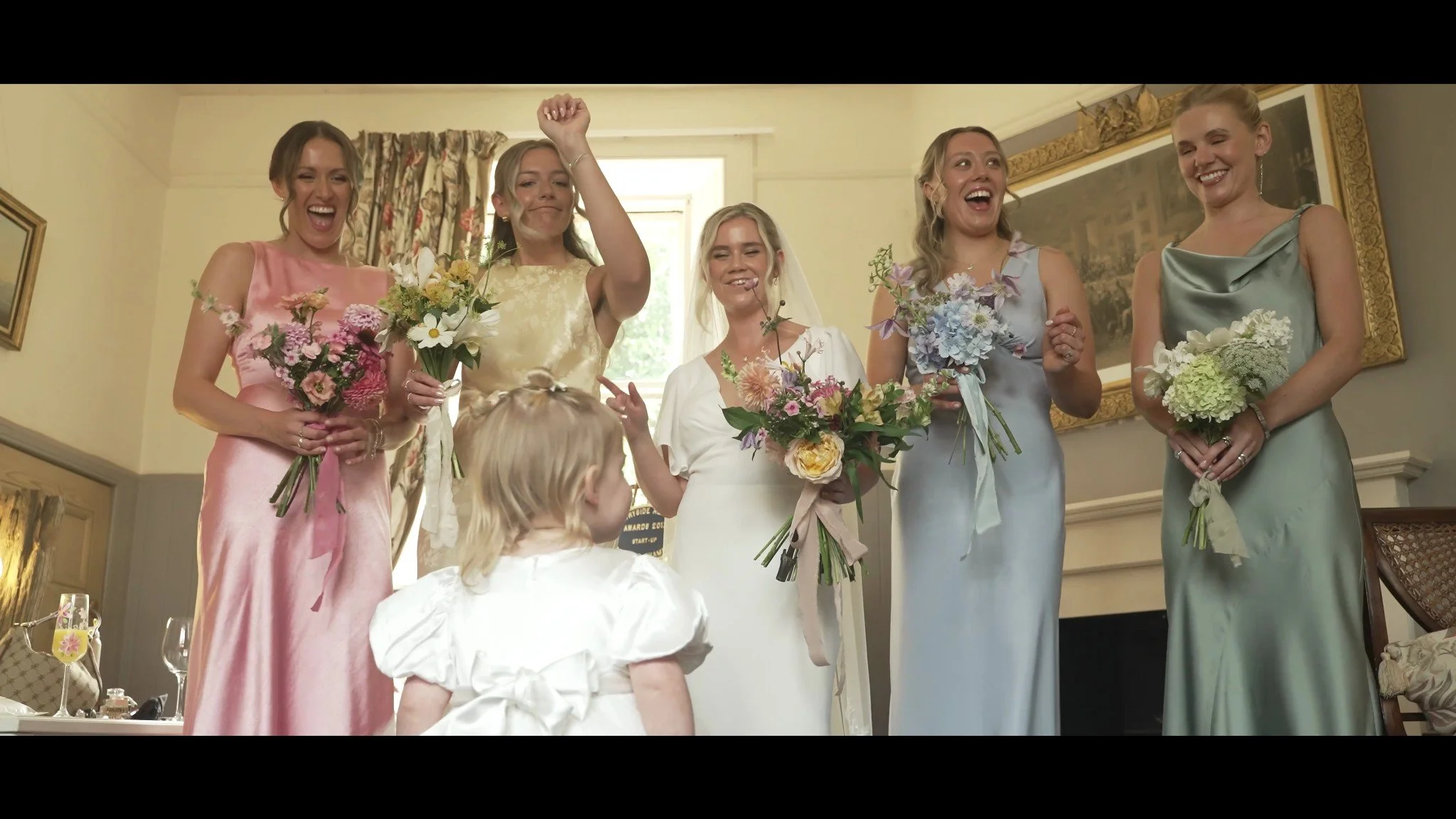 Rowan with her bridesmaids and a little girl in a white dress