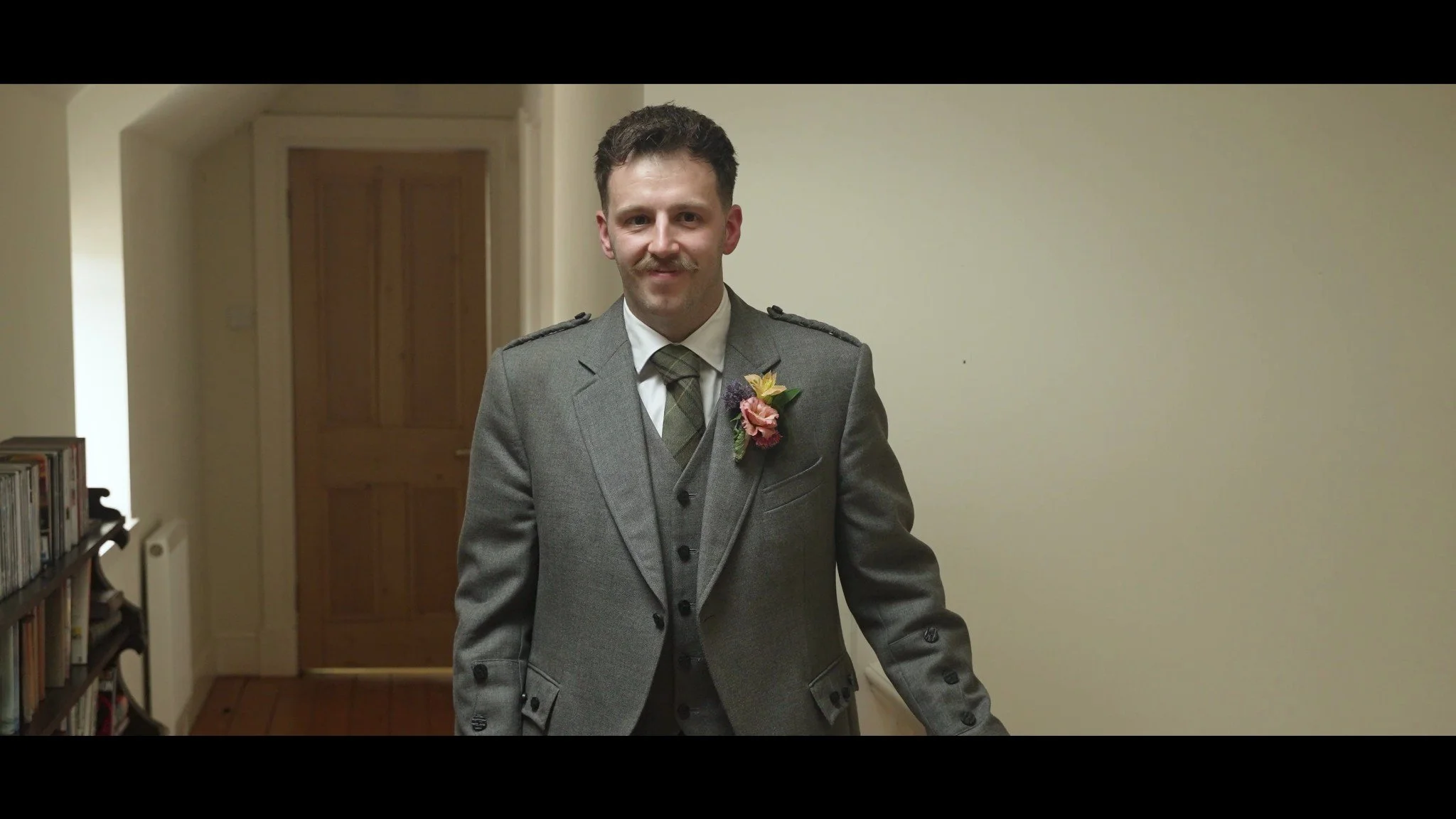 Rhys smiling in his wedding suit