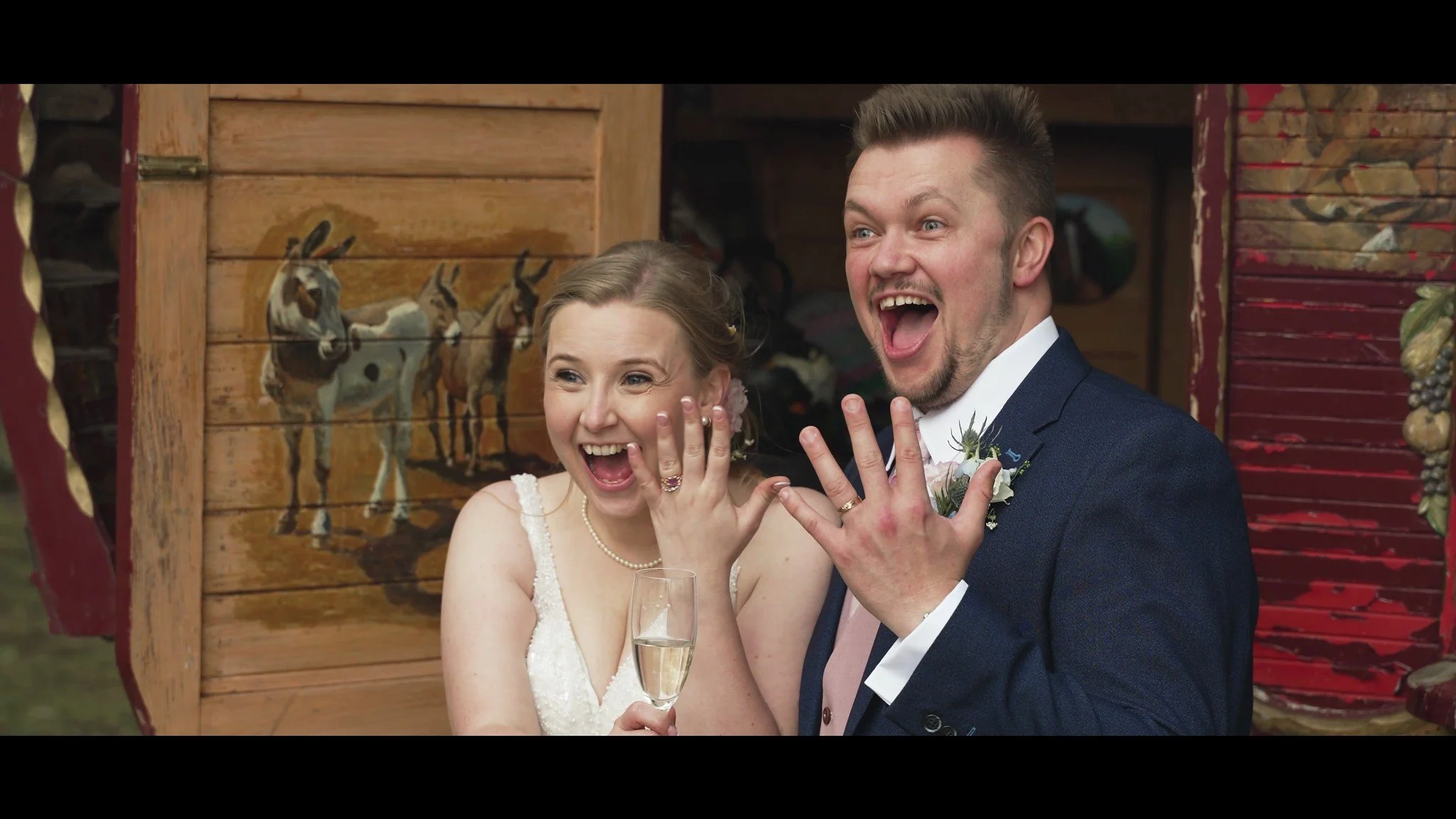 Hannah and David laughing and showing their wedding rings