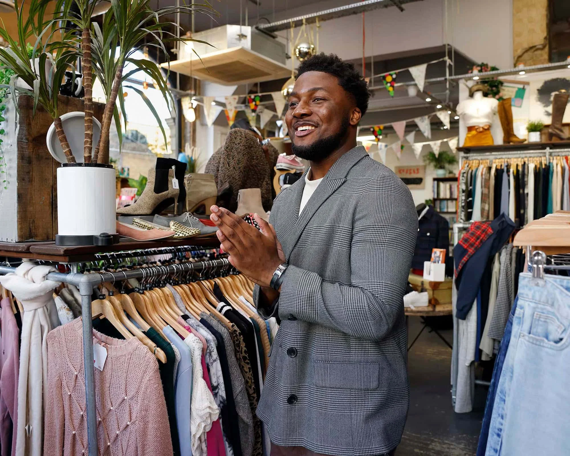 charity shop fashion | nick david | london photographer | lifestyle photographer

A young man trying on a jacket in a charity vintage clothes. 