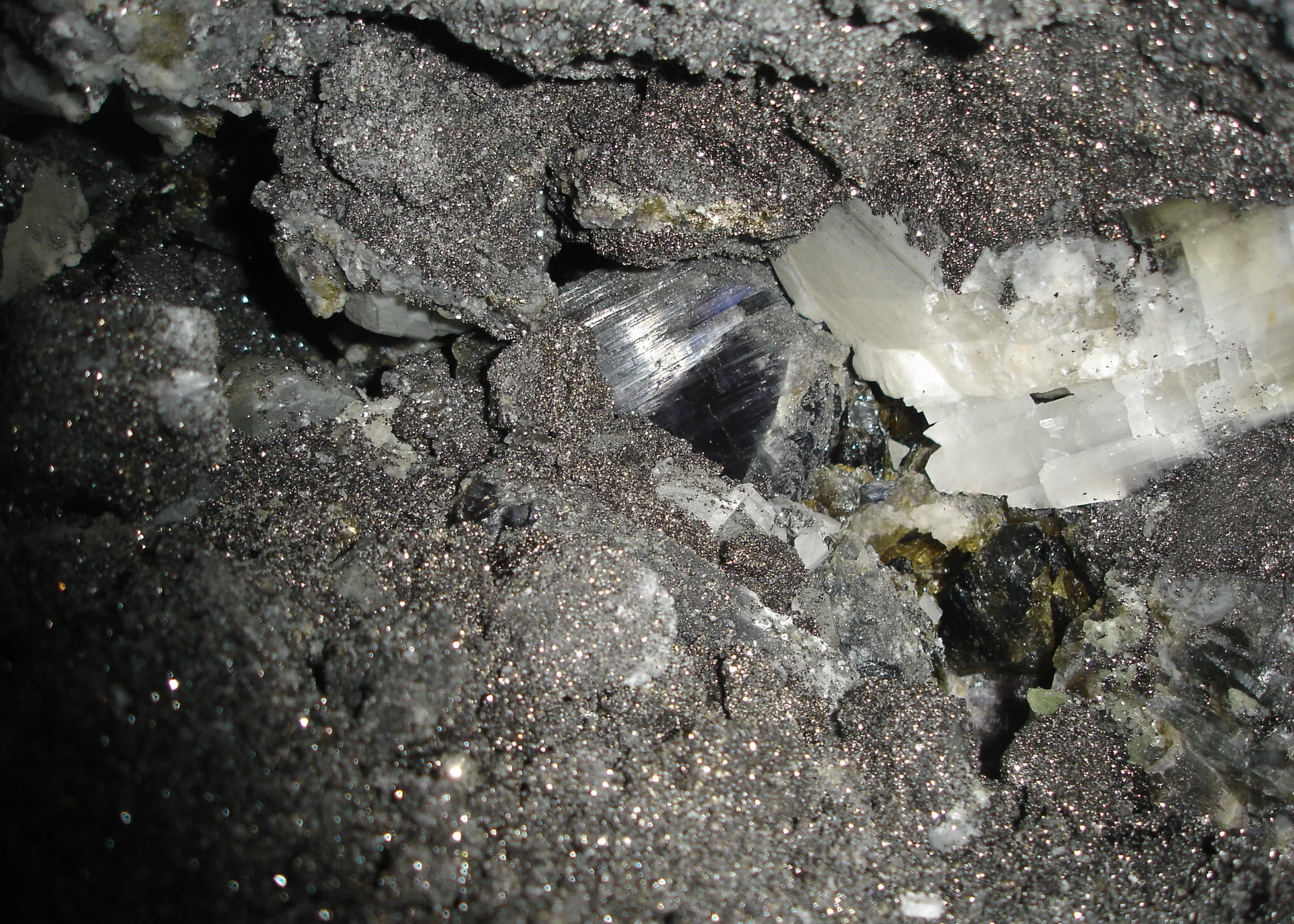 Tanzanite pocket underground with its associated minerals.