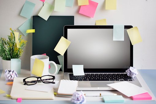  Messy office table top with many blank sticky notes. Text space image. 