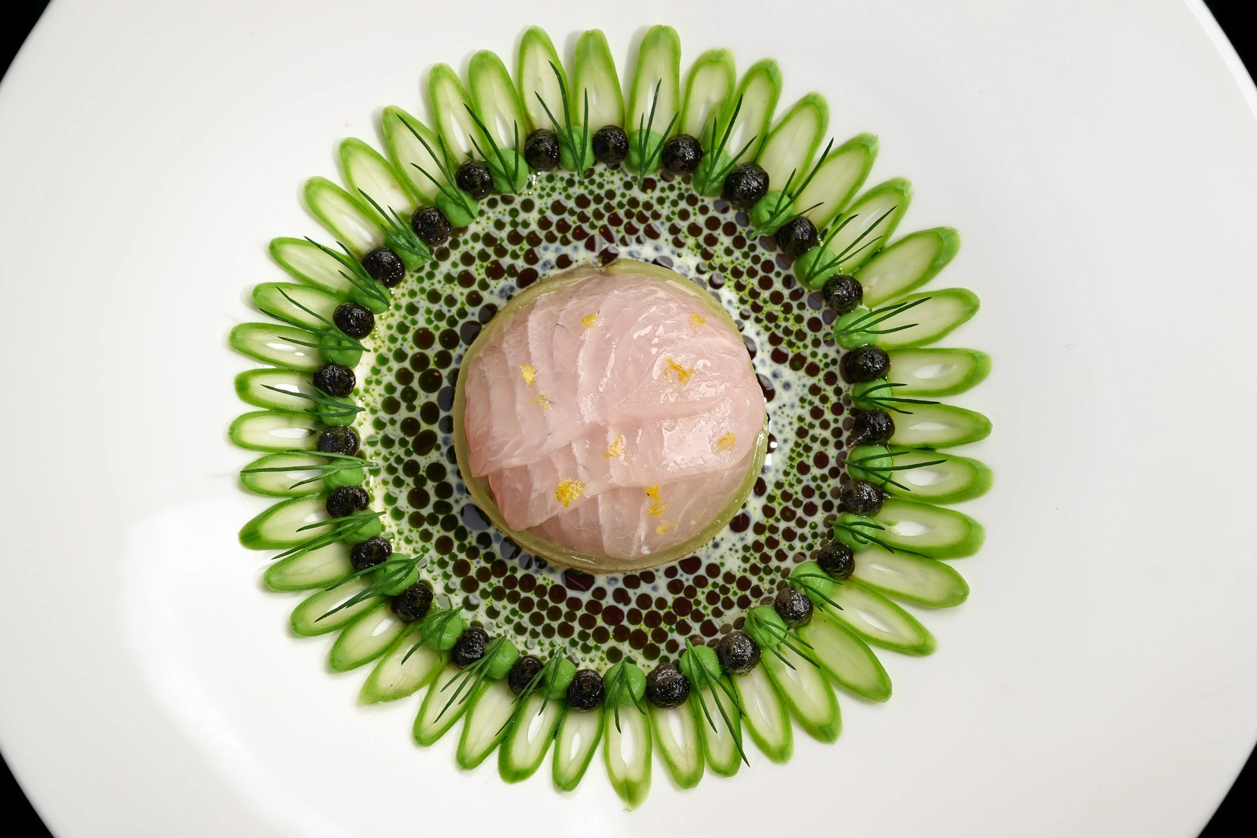 Hamachi with long bean slices and black garlic, a Borderless Cuisine dish by Christiaan Stoop, 2024