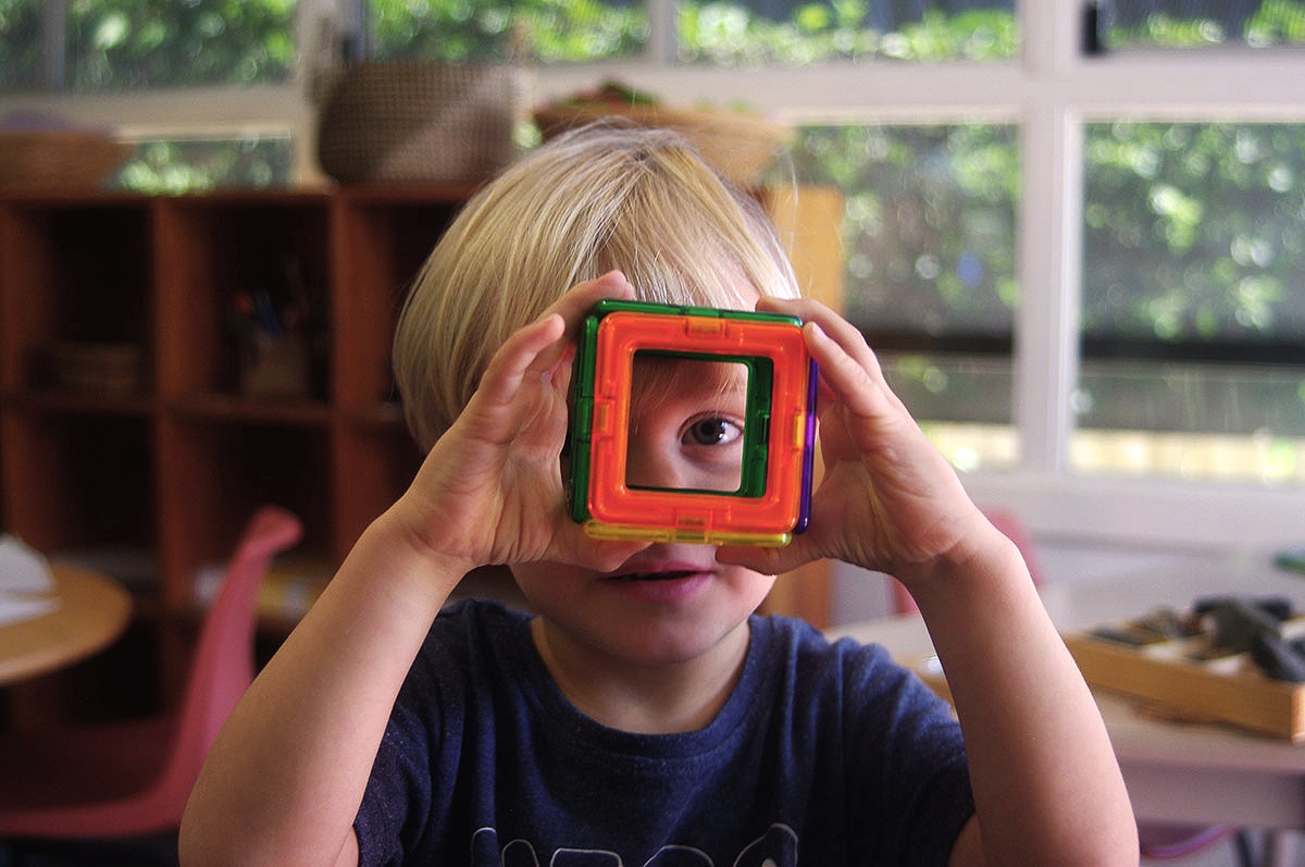 Rosellas Community Preschool child looking through toy.jpg