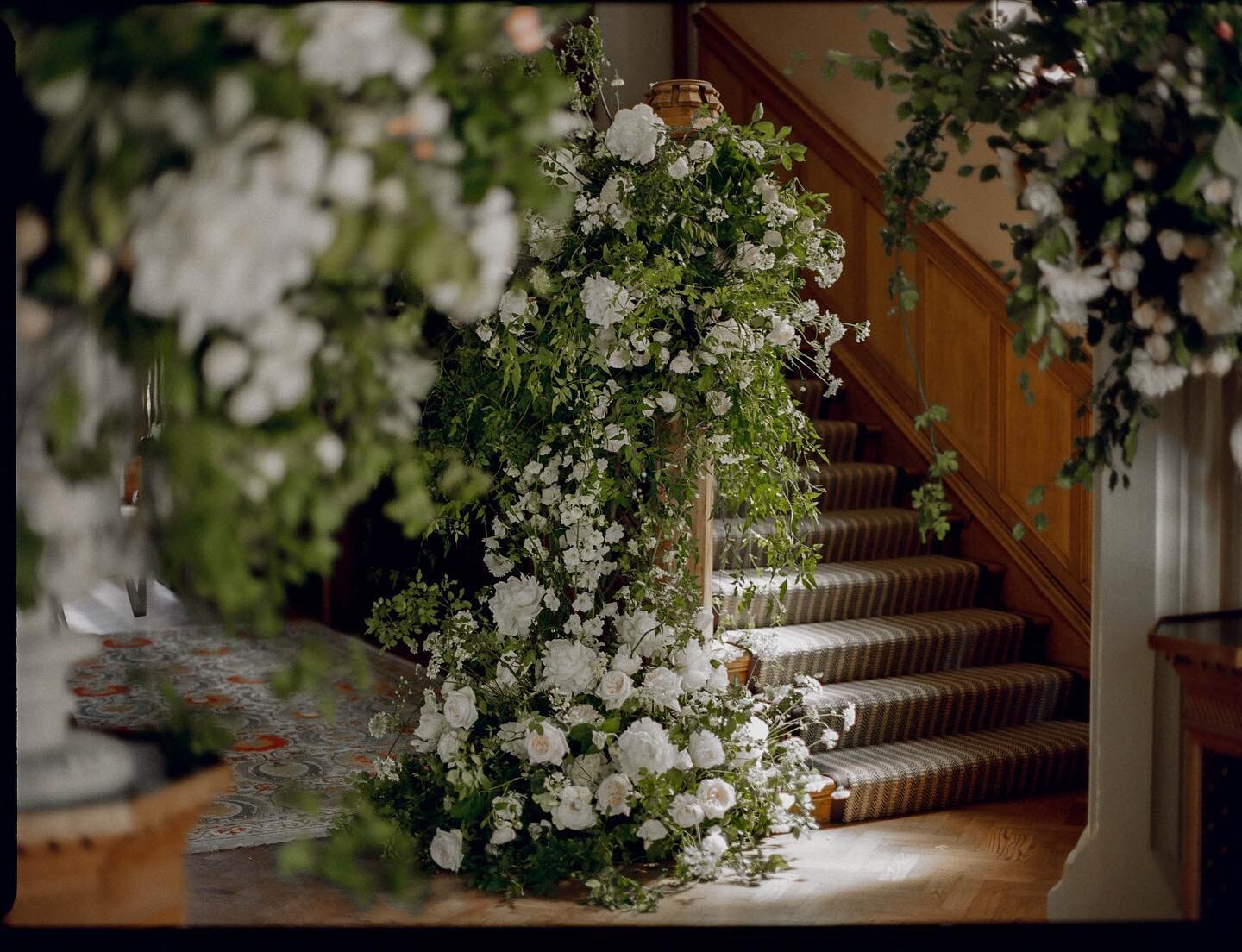A staircase festooned with rose trails, jasmine, roses, peonies and orlaya @oakleycourt for A&amp;S.

Planner - @arc.events_ 
Photographer - @joannabrownphotos