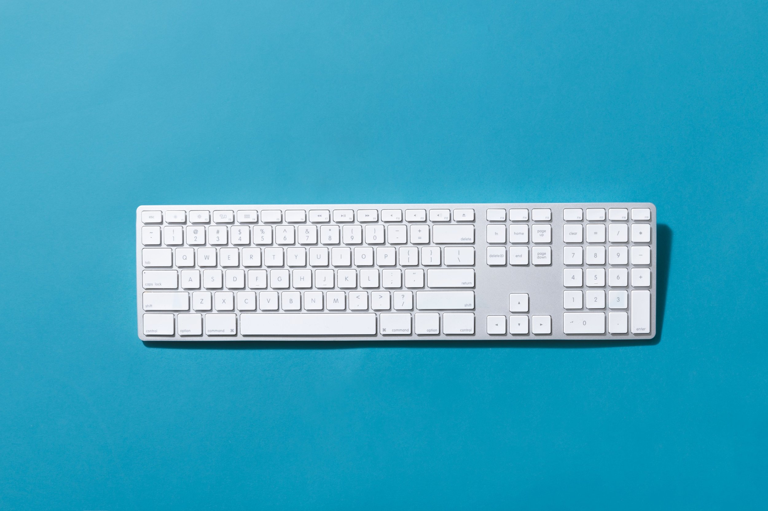 silver-keyboard-on-blue-background.jpg