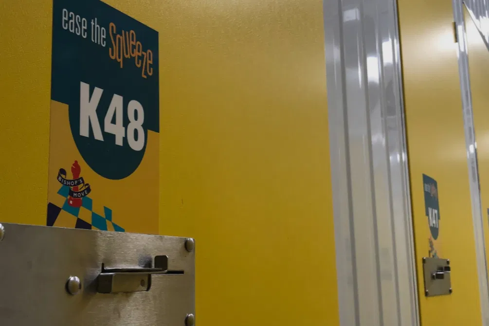 A close-up of secure yellow indoor storage unit doors, showing the clean and organized environment.