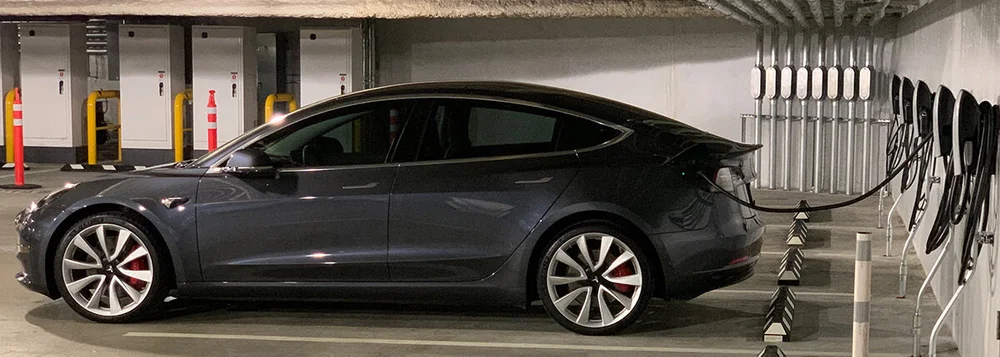 Electric vehicle charging bay showing the kind of multi-vehicle charging load that an EV energy management system shares across one service