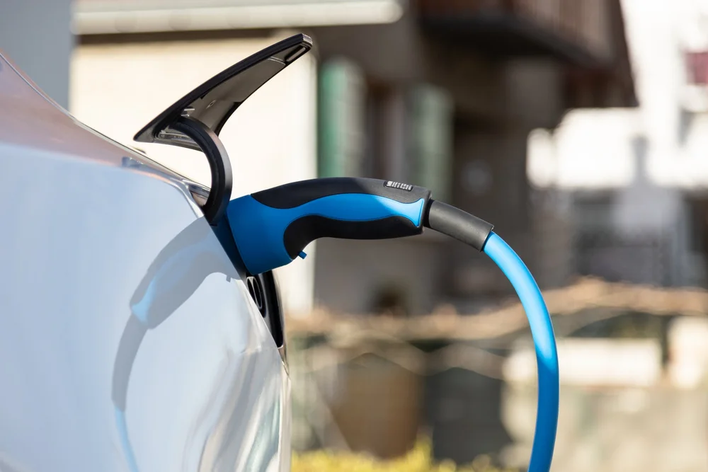 Electric car plugged in and charging at a Level 2 charging station