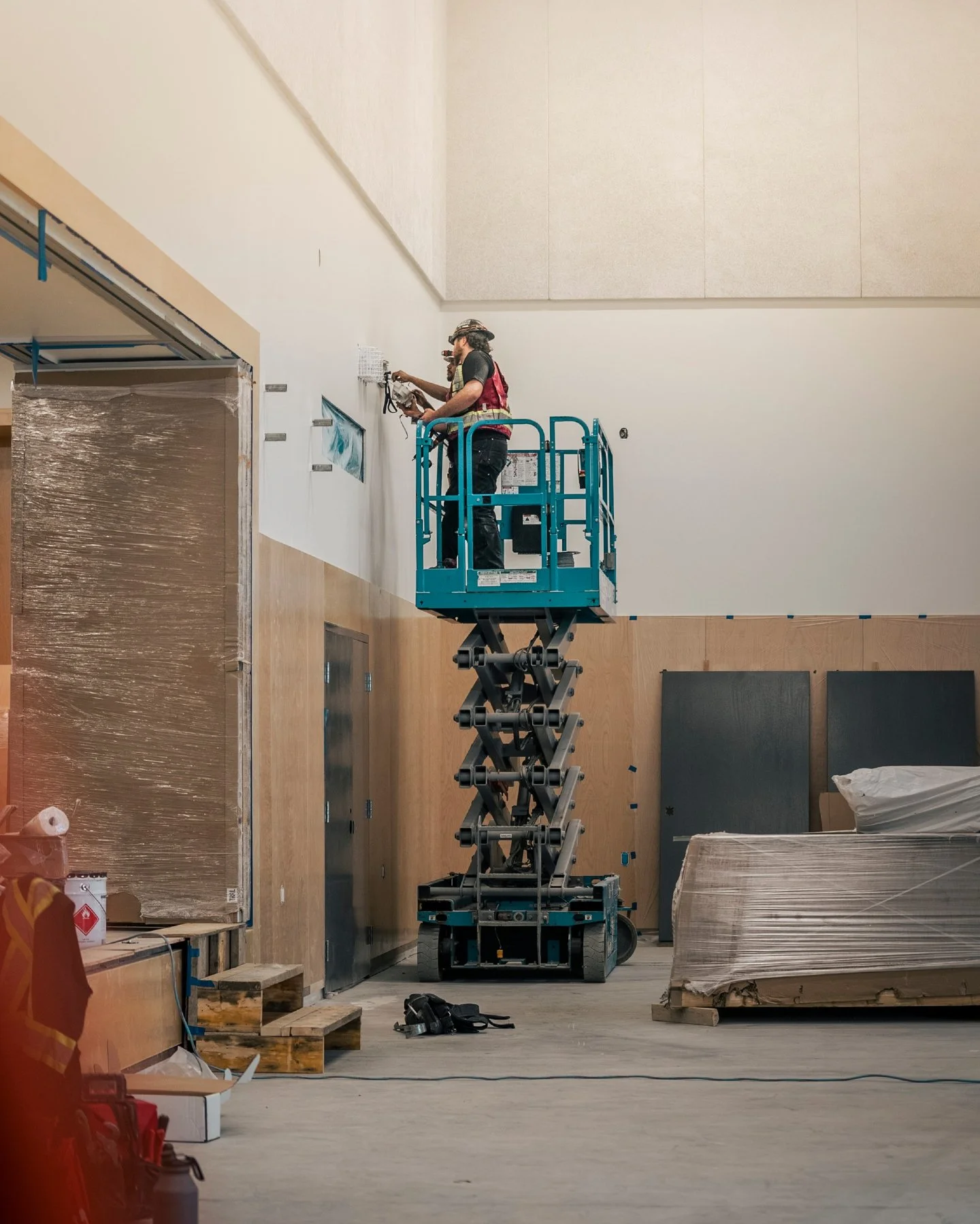 Some rooms you can't reach from a ladder. 📐

Two of ours at full extension, setting devices on the high wall before this one gets handed over.

Big room, big reach, and a lot of planning before anyone leaves the ground. ⚡

📍 Vancouver &amp; the Low