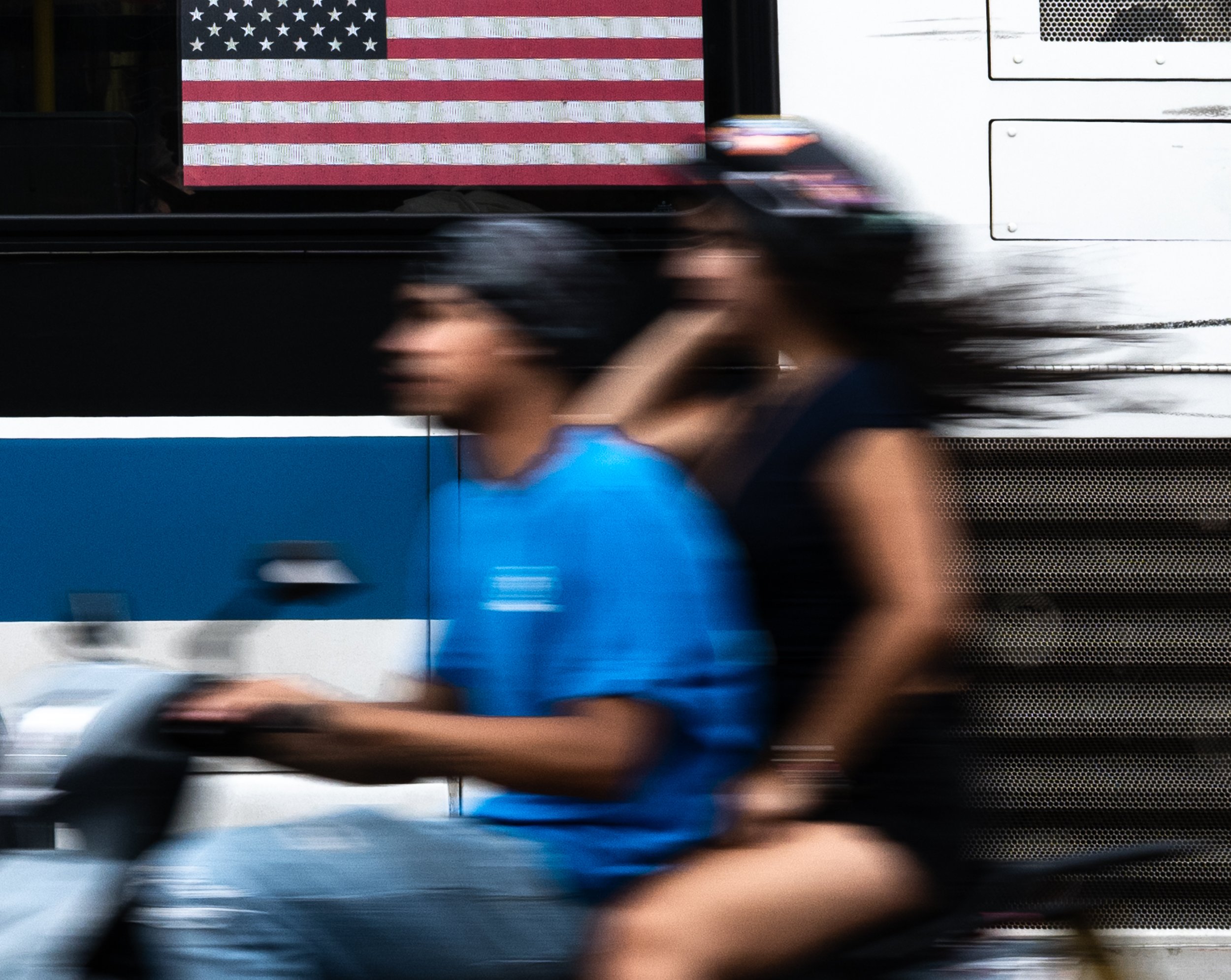 Two Scooter Riders and a Flag, Flushing Queens, 2026