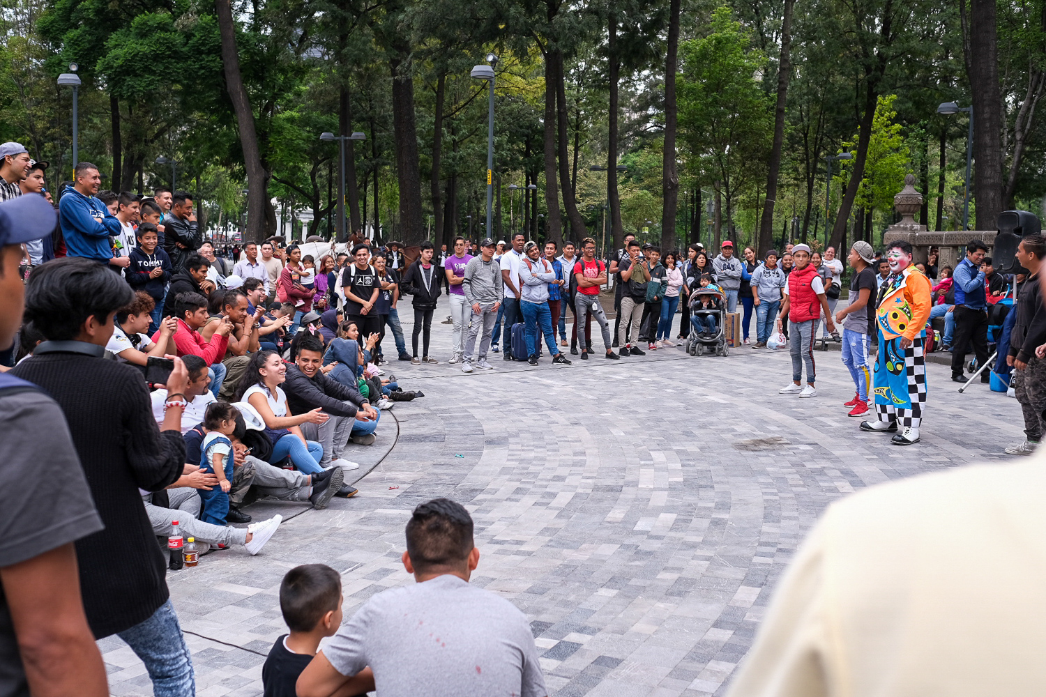 Activating public spaces can be simple. I am jealous of the amount of public spaces found in Mexico City and Puebla. Plazas, placitas, plazuelas, shaded walkways, public benches are abundant in Mexico. They are central to public life and, on any given evening, it is easy to find crowds of people enjoying the parks in their own way. Above is one example. I’m not sure why, but clowns are really popular in Mexico. They captivate crowds of people sitting in ad hoc stadium seating, made of sidewalks, fountain ledges and monuments. Within a few meters of this clown show in Alameda Central , there were ice cream vendors, rappers battling each other, and young couples enjoying some pizza on a park bench. The plaza is simply built, with very little in terms of what we would consider “park fixtures.” No basketball courts, no fields, no jungle gym. No signs telling you what you can’t do. The Alameda Central is a blank canvas on which the people of the community paint a beautiful collage made up of their favorite activities.