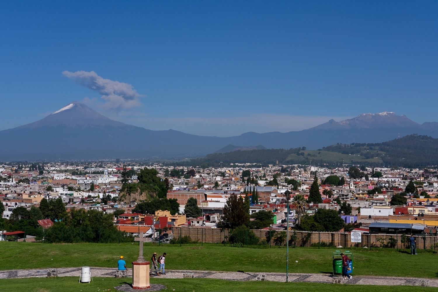  This was the view our team enjoyed in Cholula, the oldest inhabited city in Mexico. The smoking peak on the left is Popocatéptl and the group of snow-capped peaks on the right is Izztacíhuatl. These volcanoes are two of the tallest in the hemisphere