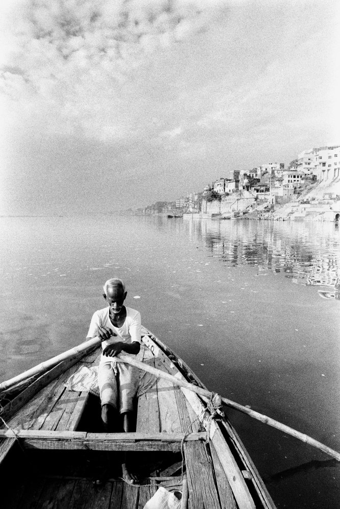 A boatman on the Ganges River along the ghats of Varanasi (Benares) Photography Pierre Toutain-Dorbec.jpg