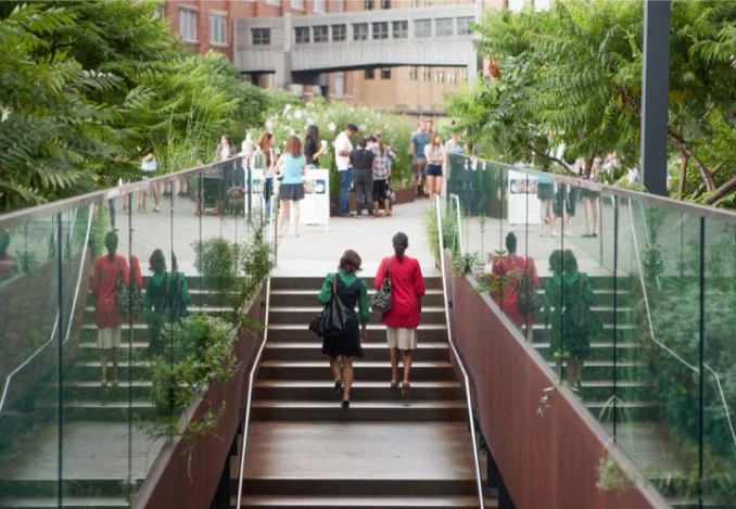 People navigate a staircase in a lively city setting, showcasing the dynamic atmosphere of urban life.