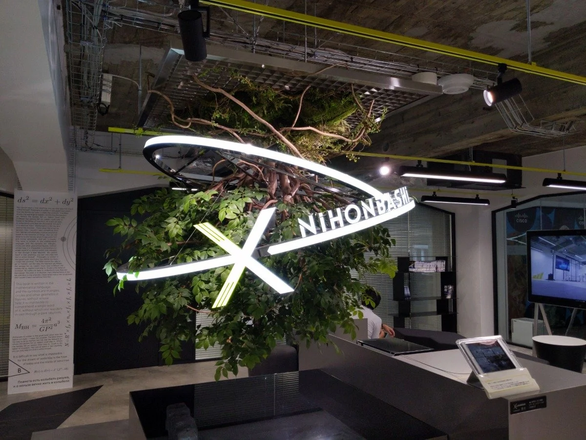 A large Nikon sign positioned centrally within a room located in Nihonbashi, Tokyo, showcasing the brand's identity.