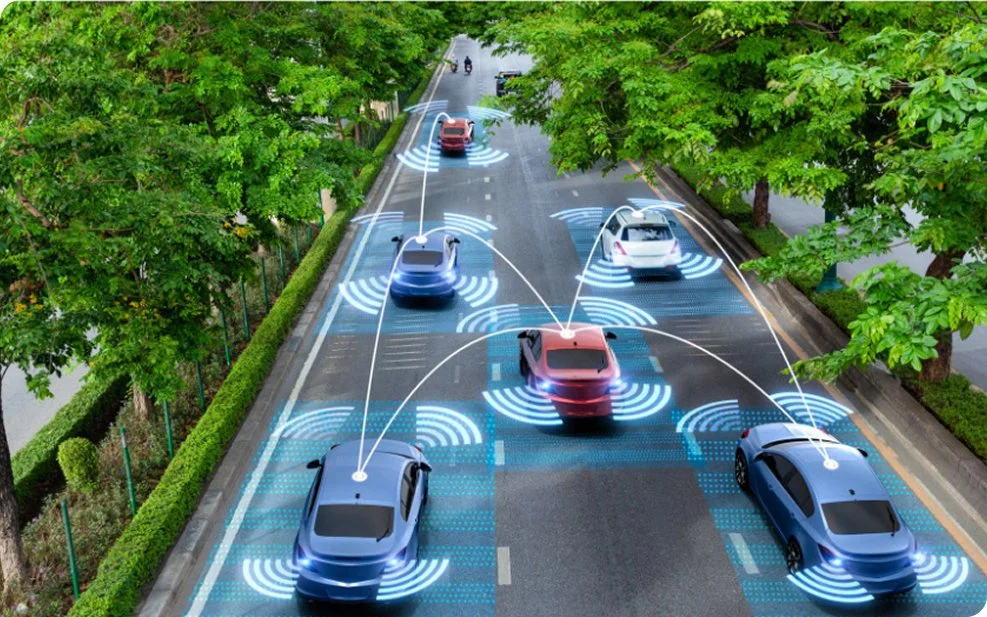 A scene of autonomous vehicles on a road with traffic signals, highlighting advancements in national infrastructure technology.