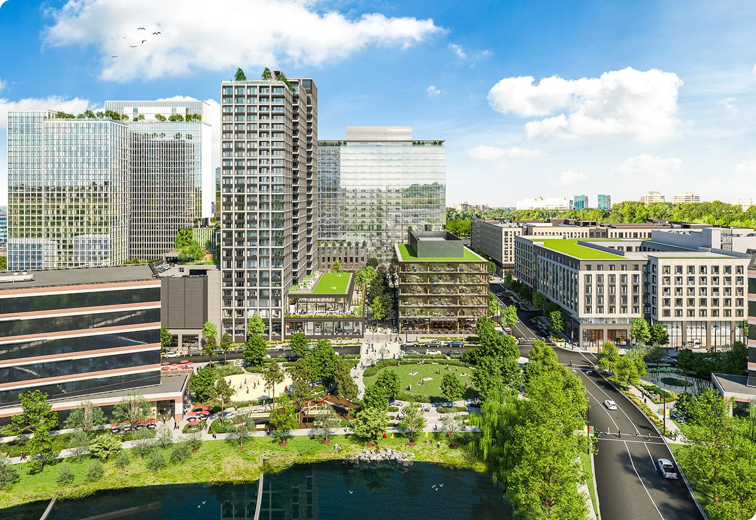 Modern urban landscape with high-rise buildings, greenery on rooftops, and a park by a waterway. People are visible on pathways and in the park area. The scene is under a sunny blue sky with some clouds.