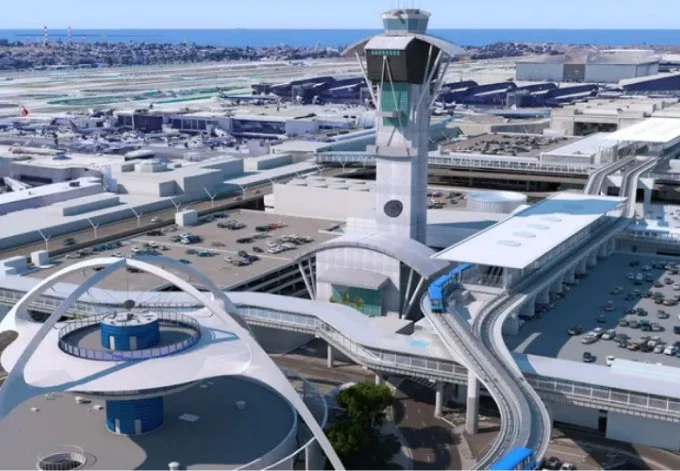 Lax airport scene featuring a large terminal building alongside a prominent control tower against a clear sky.